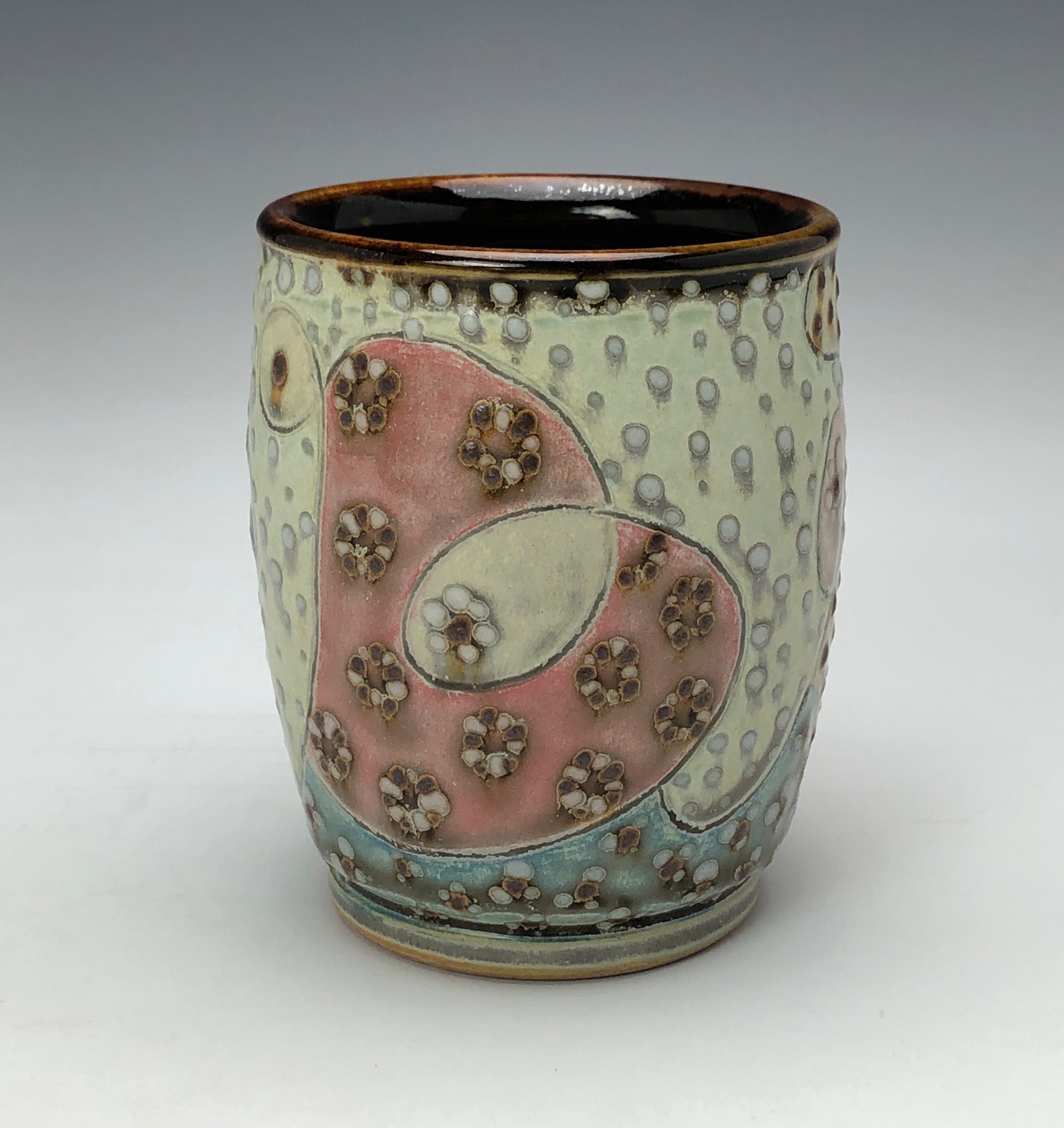  Yunomi 5- Casual drinking cup made from a smooth white porcelaneous clay body. Pattern Medley patterns are made with slip and glaze dot patterns. Translucent vellum glaze over various underglaze colors. 