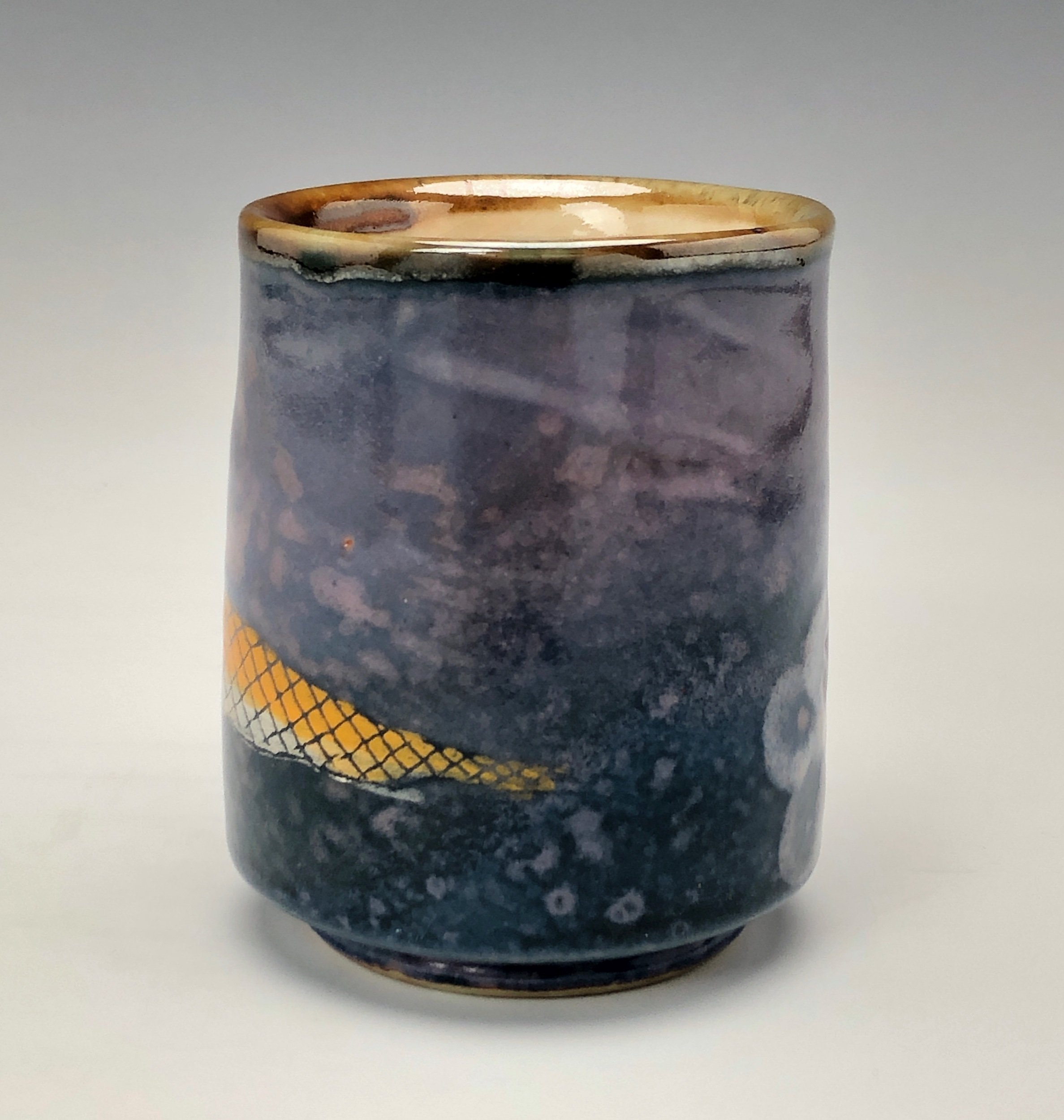  Bruce Gholson, Bulldog Pottery, Seagrove, North Carolina  Yunomi 6- Casual drinking cup made from porcelain. This cup is glazed with a lavender blue shino with a drawn fish in orange over glaze. 