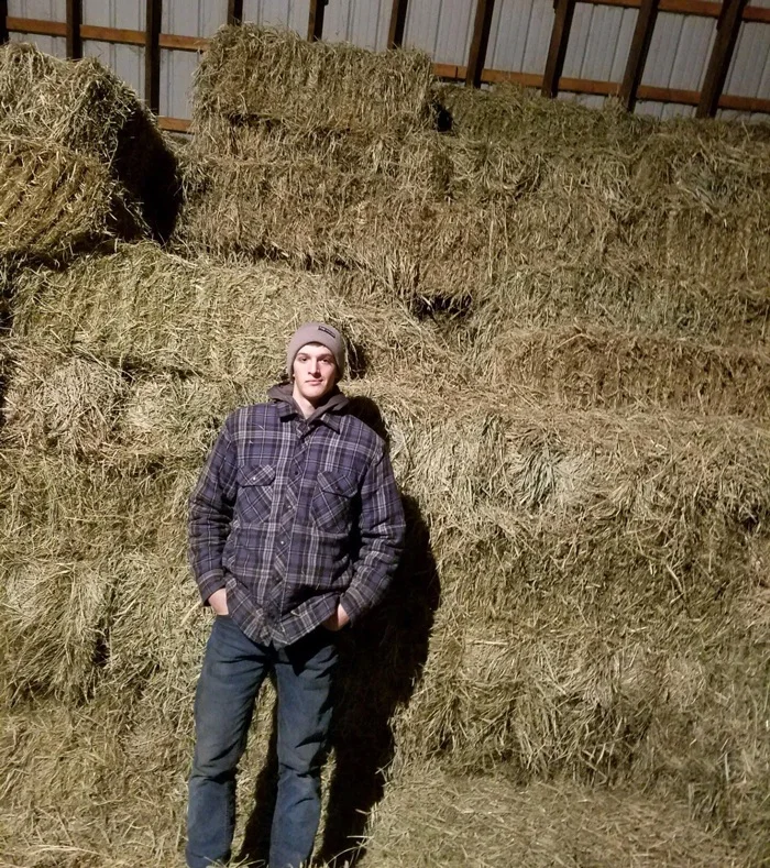 young-farmer-in-front-of-hay-1.jpg