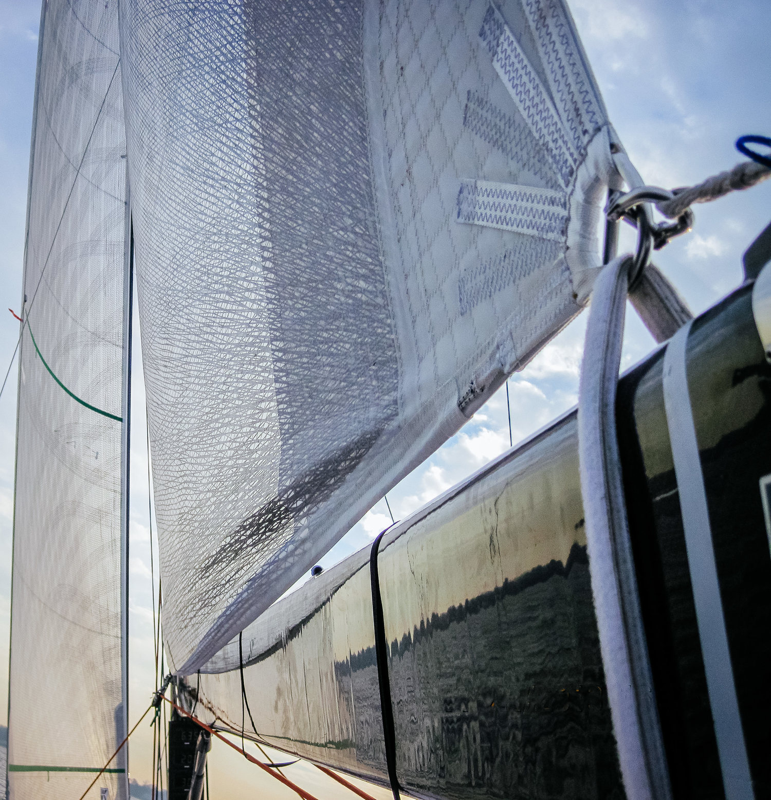 A Titanium loose-footed mainsail. A velcro strap around the boom takes the place of a clew slug or clew car.