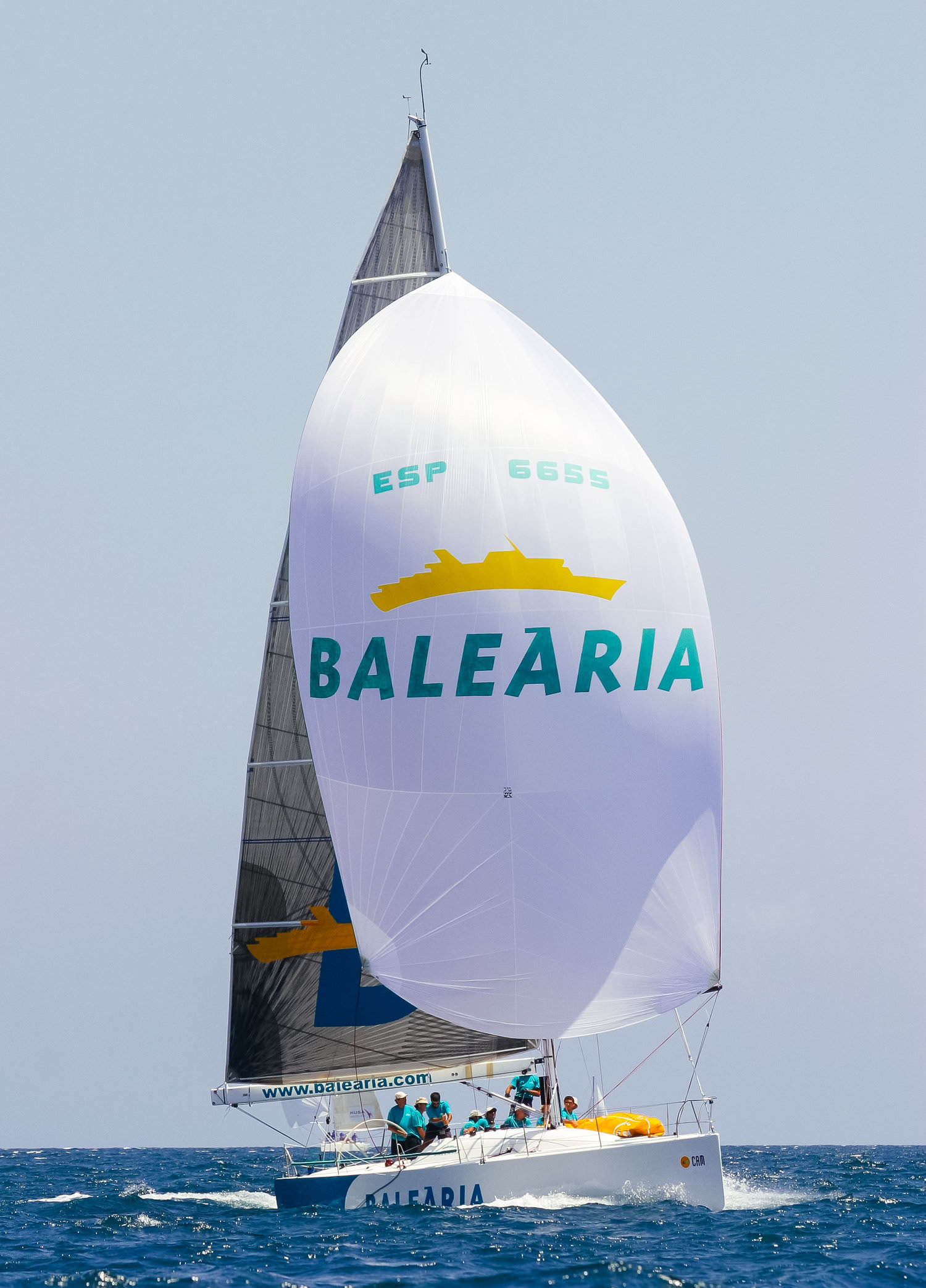 When reaching, symmetrical spinnakers are trimmed with the tack lower than the clew to move the draft of the sail forward and to open the leach to reduce healing, as shown above.