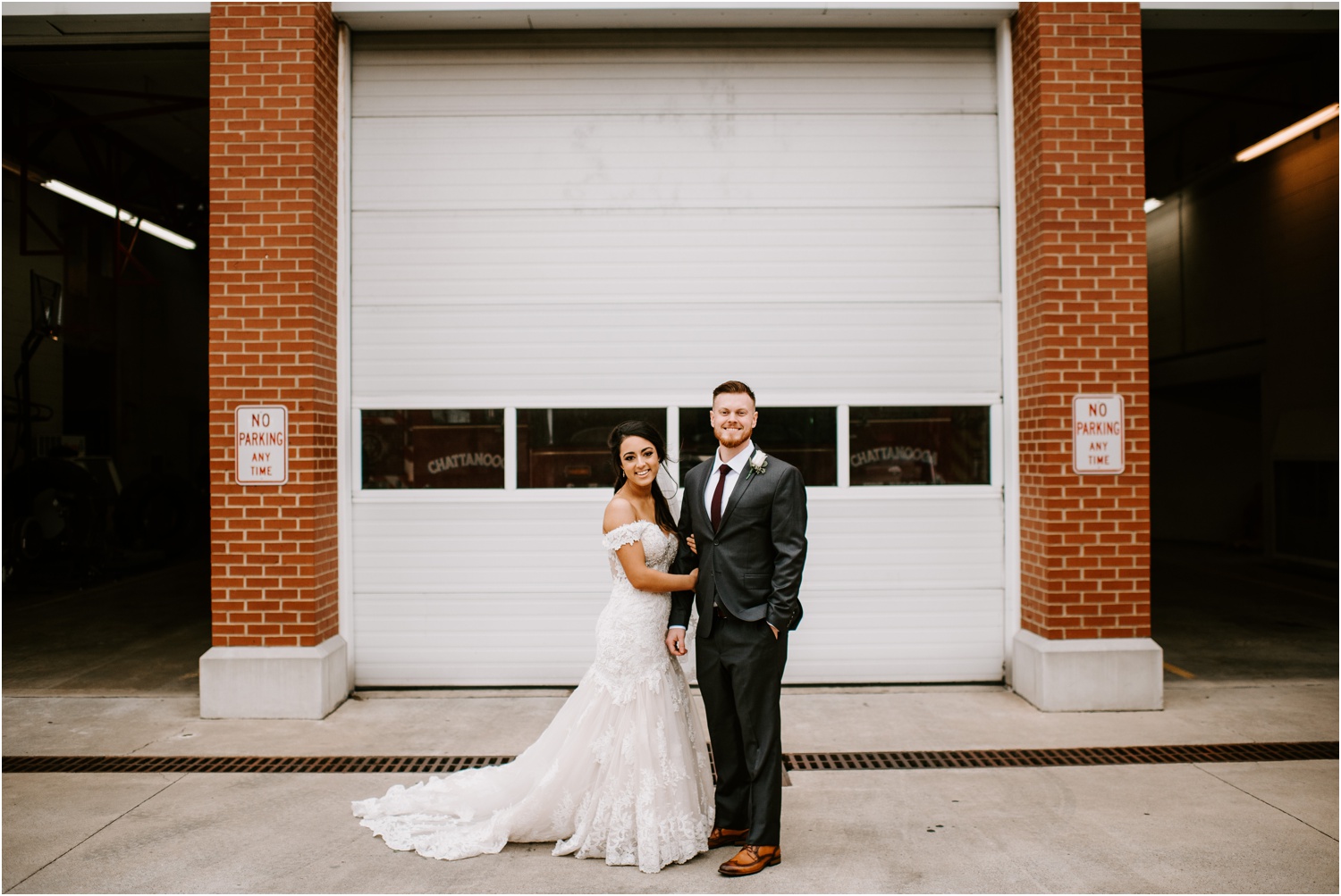fire station bride and groom portrait in front of white garage door