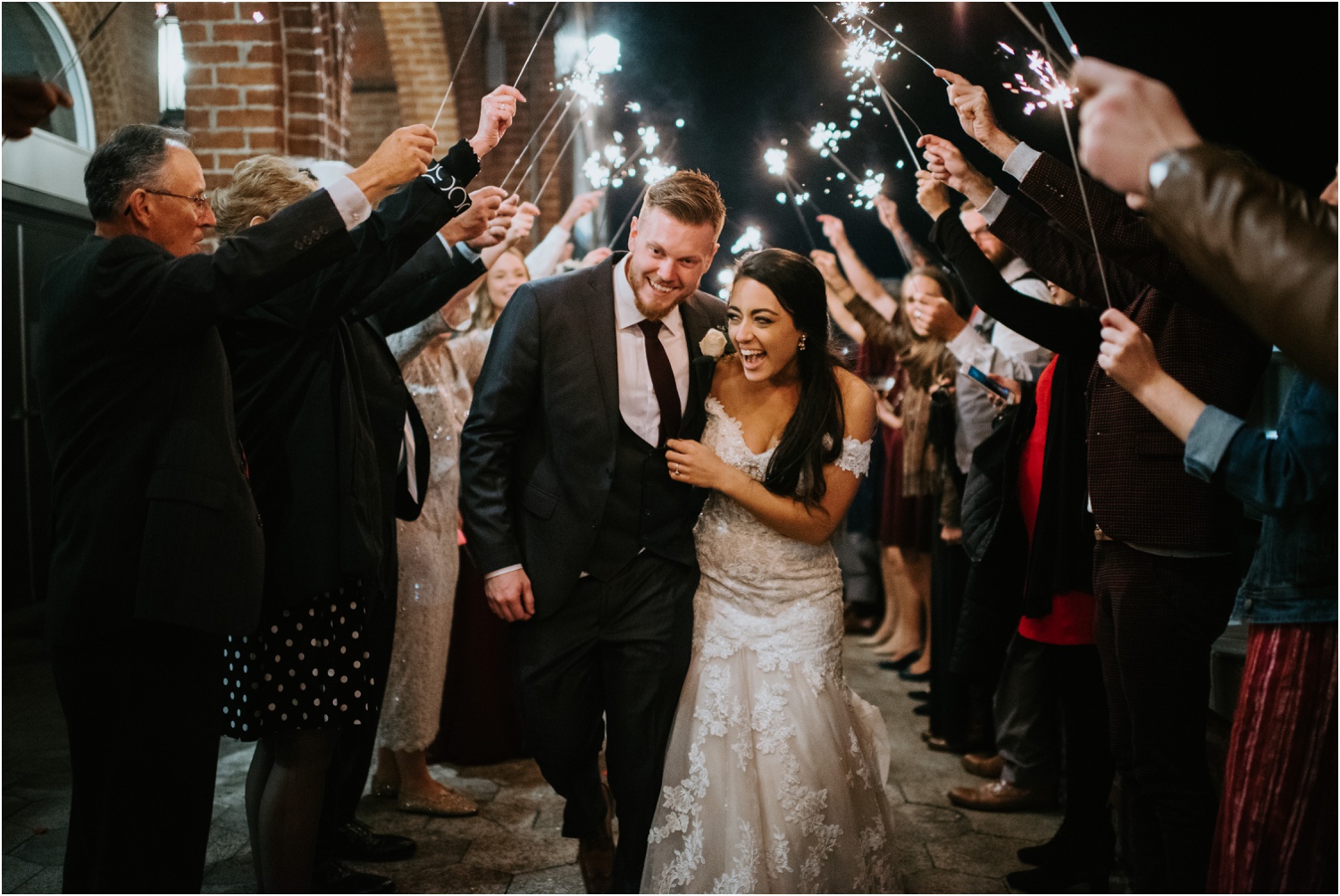 sparkler exit bride and groom laughing and walking