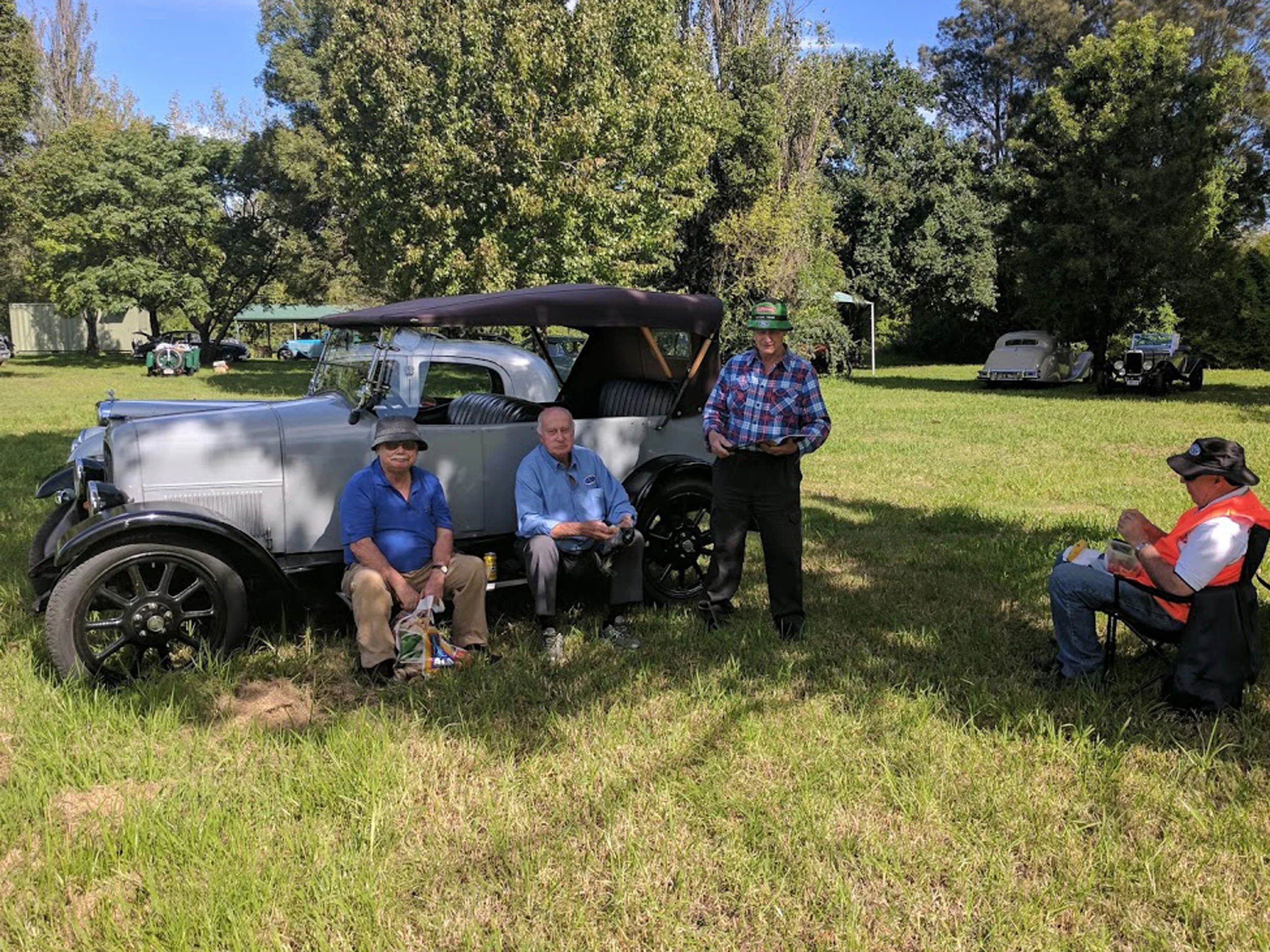 Alan Baker flanked by Brian Wilson (left) and Richard Heher (right) savouring the comfy running board of his Fiat 501. Robert Phillips looking on. Photo by Jeremy Morris.