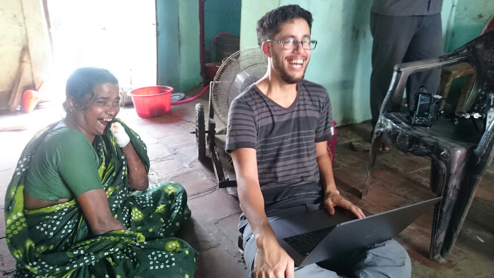 Daniel Christiansz reviewing footage with Nagammal in her home in India