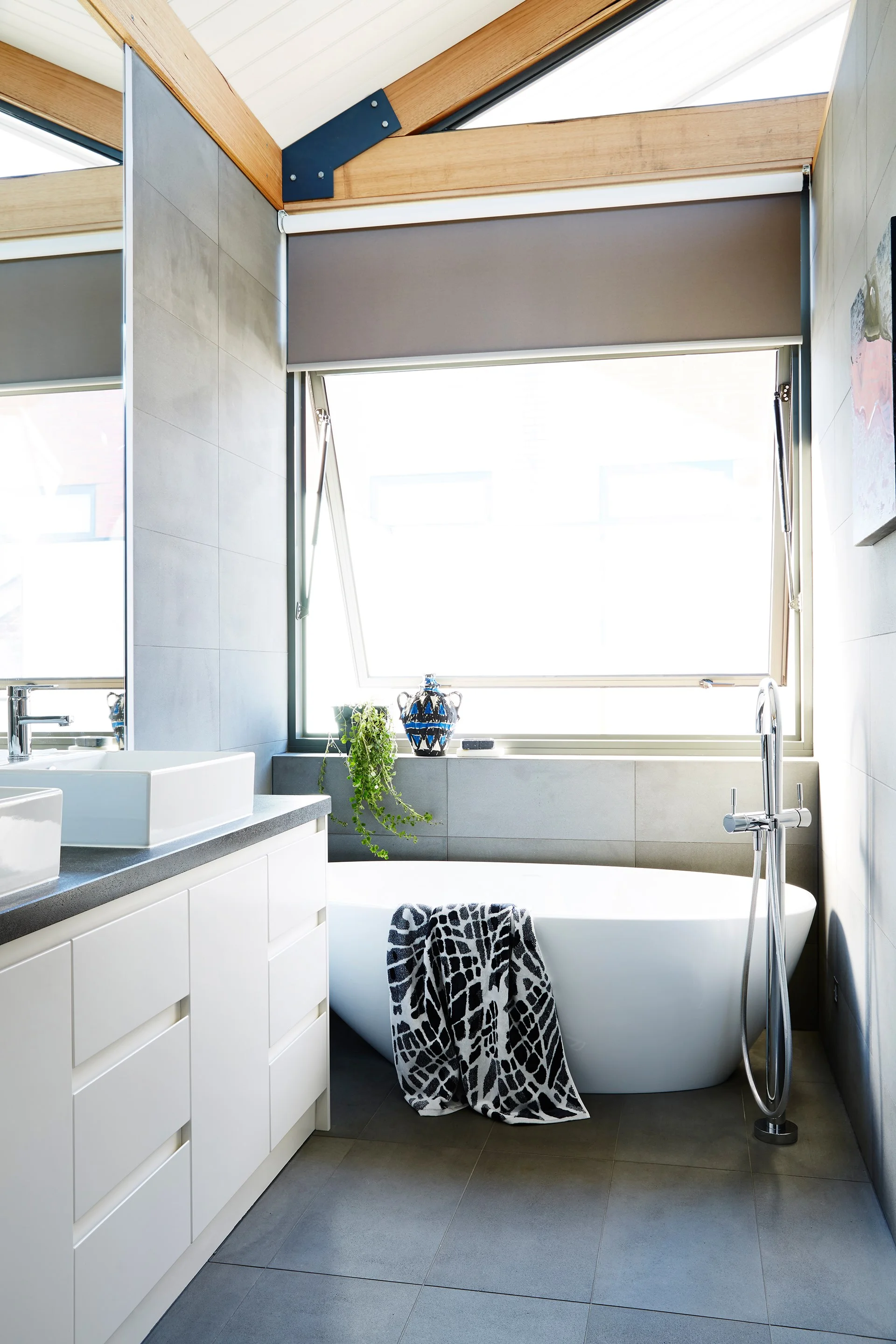 Try a contemporary design with hand-less drawers and a statement bath to die for.