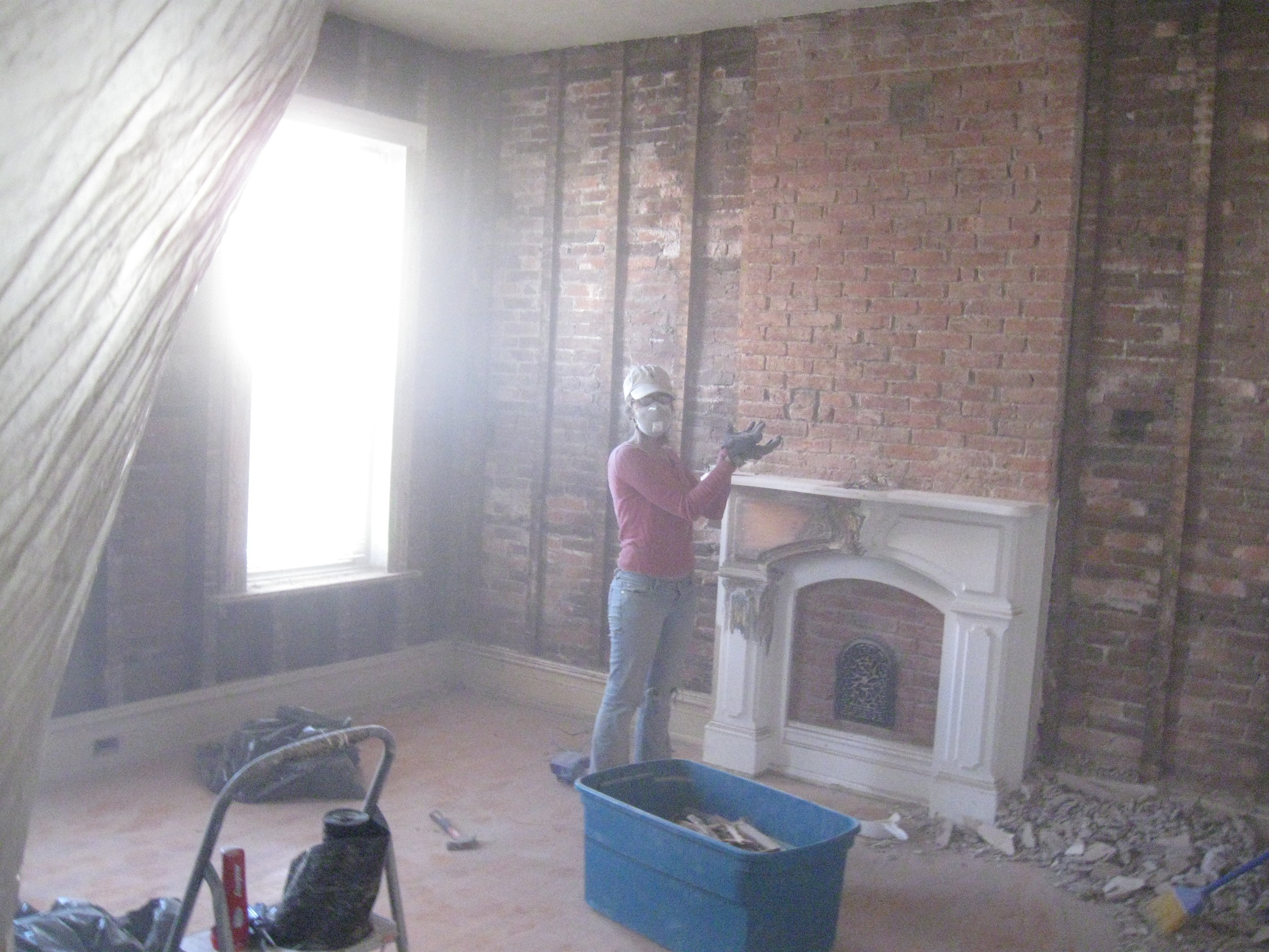 My lovely wife, Athena, showcasing our freshly demolished living room, in 2011.