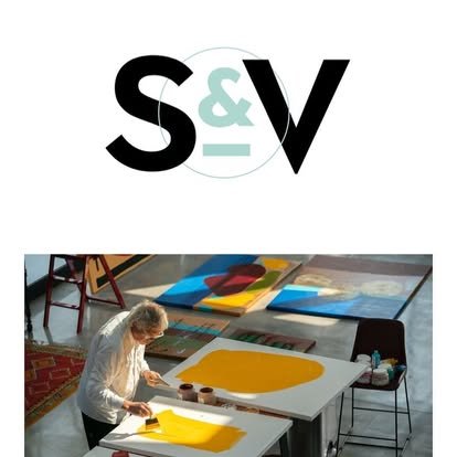 A woman working on an art project with yellow paint, surrounded by large canvases and art supplies in an art studio.