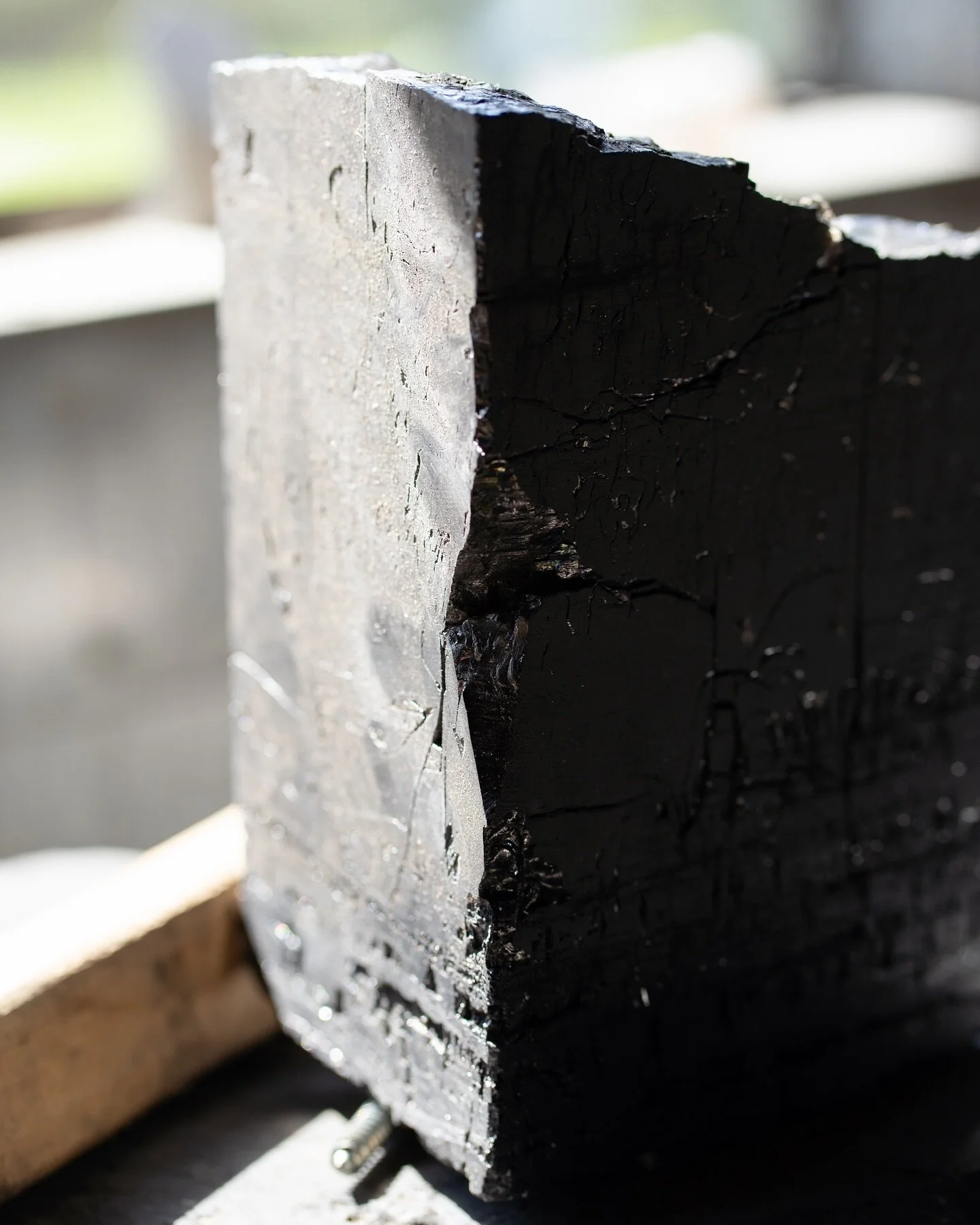 Our process begins with 2,000-pound coal boulders, sourced directly from the mine where they are rough-cut into table-sized blocks.

With precision, these blocks are shaped into functional sculptures. The polished surfaces of our coal pieces showcase