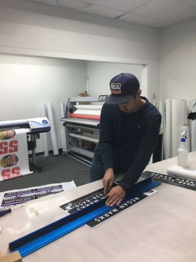 Aaron finishing off some custom realtor signs