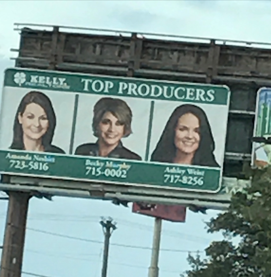 Owner of Sign This Custom Signs and Design featured (center) as a Kelly, Realtors Top Producer!