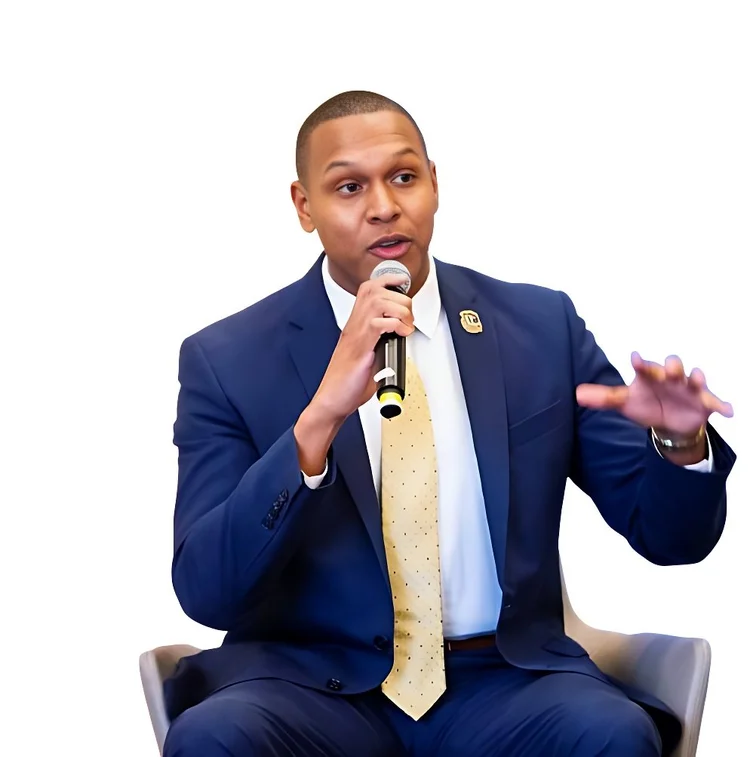 AI keynote speaker Stephen Rowe holding a microphone during a seated conversation