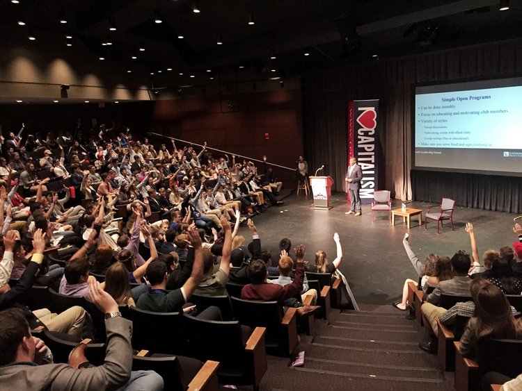 Stephen Rowe leading a training for a packed auditorium
