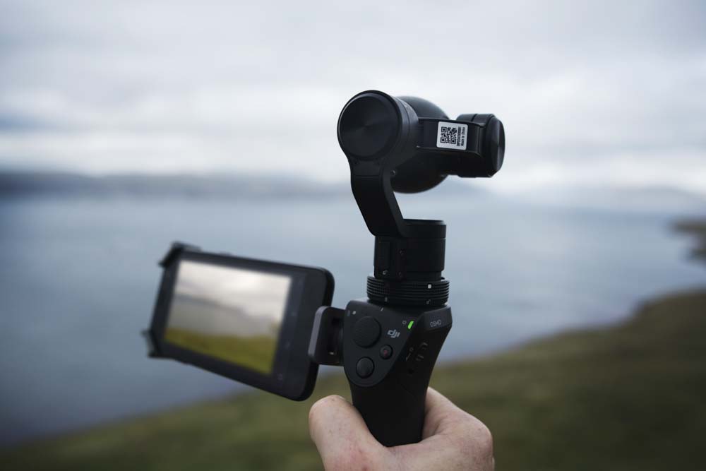Cold filmmaker hand and DJI Osmo on location. 