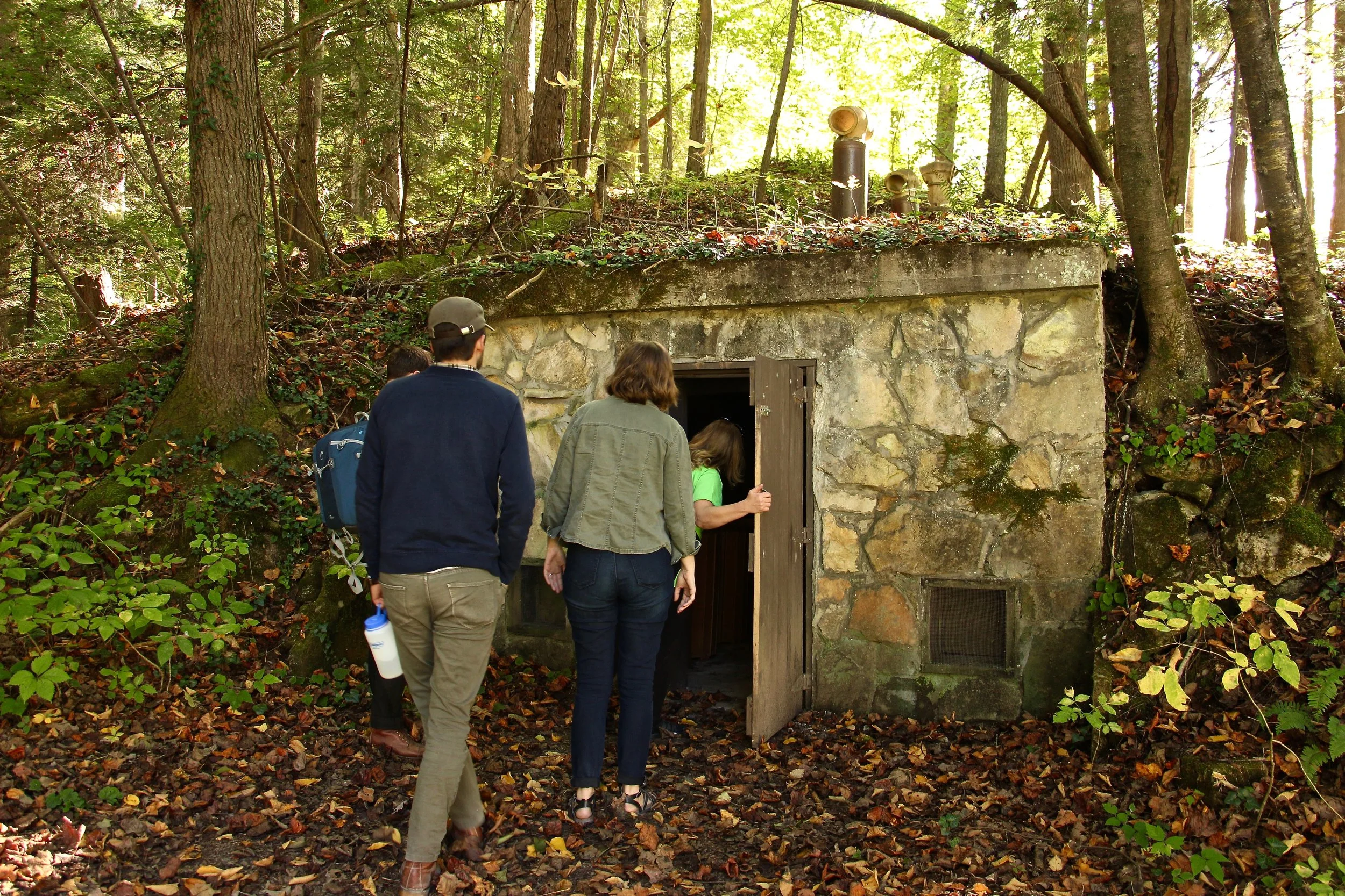 RUX members exploring a cellar built into a hillside. During our visit, the cellar was being used to store a crop of potatoes from the school's farm.
