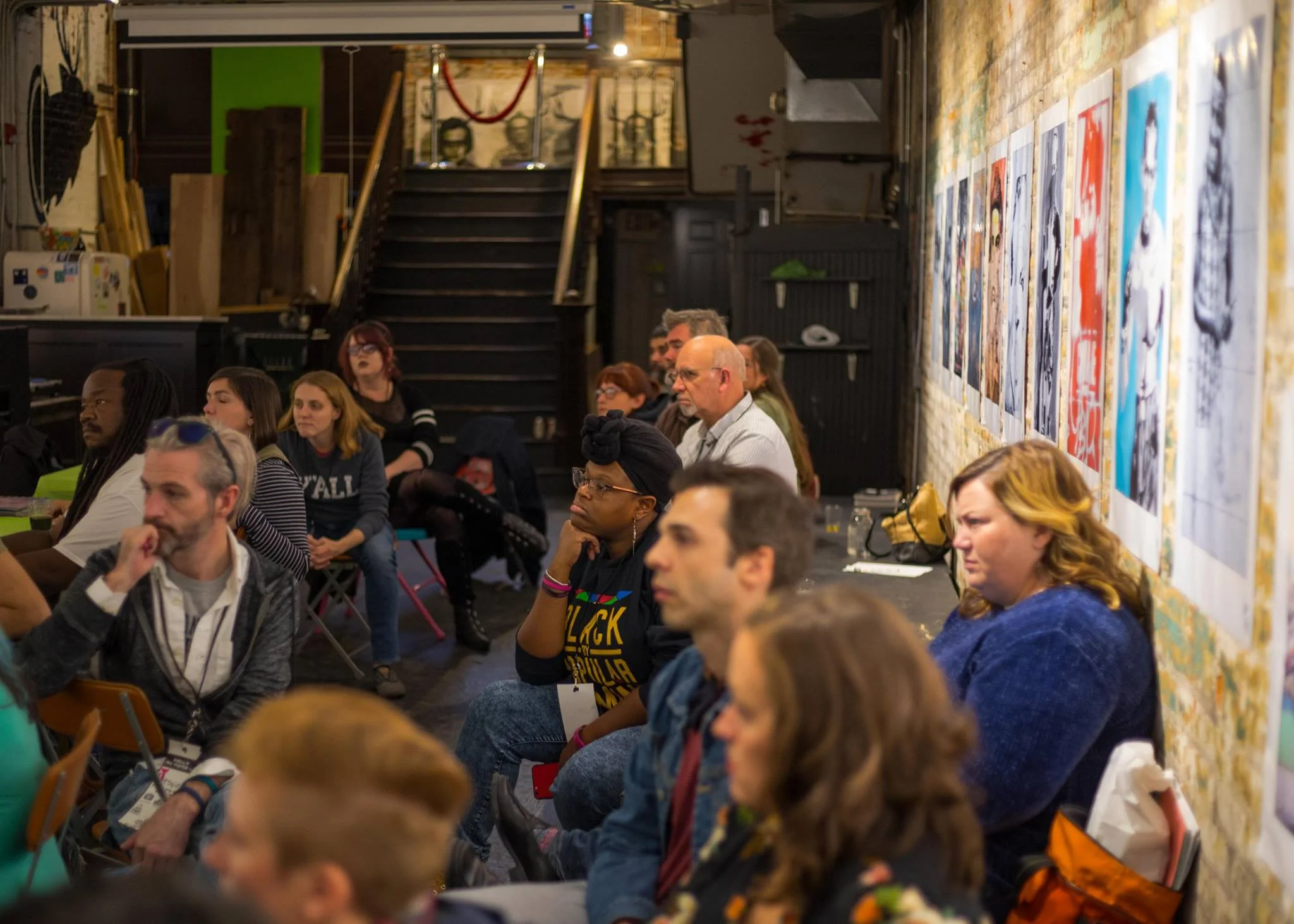 RUX 2018 Cohort members listen to hosts at BLDG during the Covington Community Intensive.