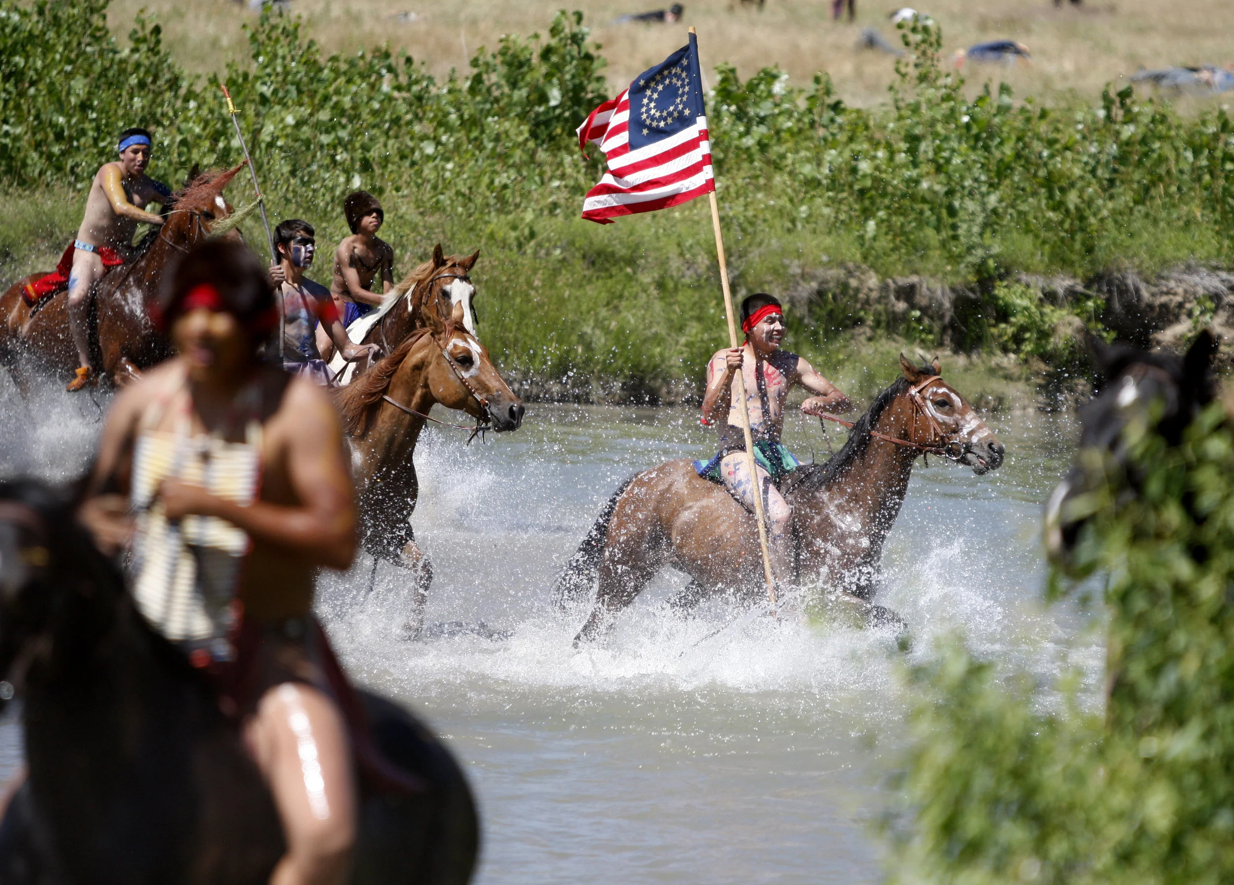 Actors return across the river after defeating Custer in the annual Battle of the Little Bighorn Re-enactment held on the Crow Reservation.