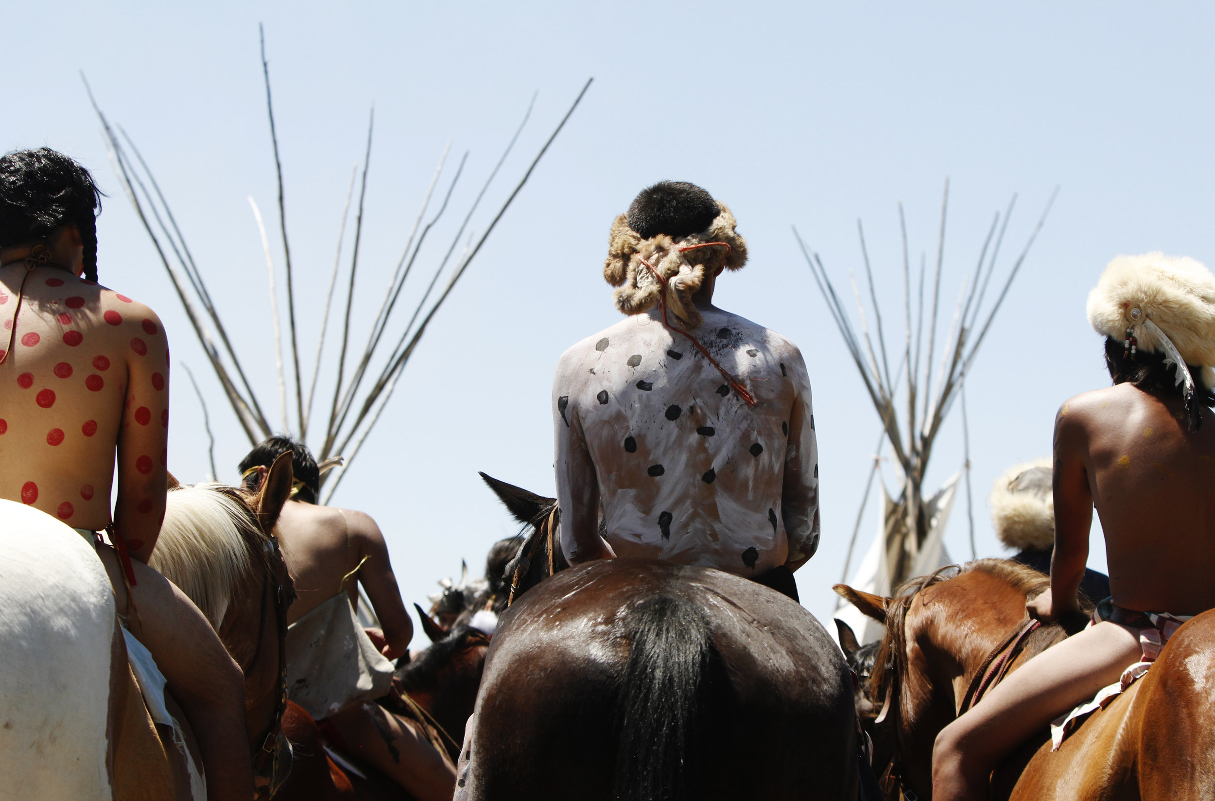 Riders wait for direction after the Battle of the Little Bighorn Re-enactment. The annual battle takes place on the Crow Reservation and the mostly teenage-riders are bareback while they run their horses at high speeds across a river and fields.