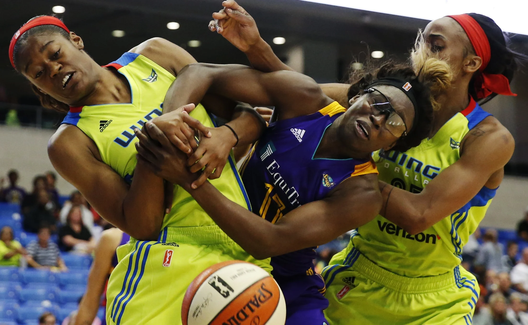 Dallas Wings guard Kaela Davis (10, left) and Dallas Wings forward Glory Johnson (25, right) battle Essence Carson of the Los Angeles Sparks (17, middle) for a loose ball during the second half of a WNBA basketball game between Dallas Wings and the Los Angeles Sparks in Arlington, Texas, Friday, June 9, 2017.(Tailyr Irvine/The Dallas Morning News)