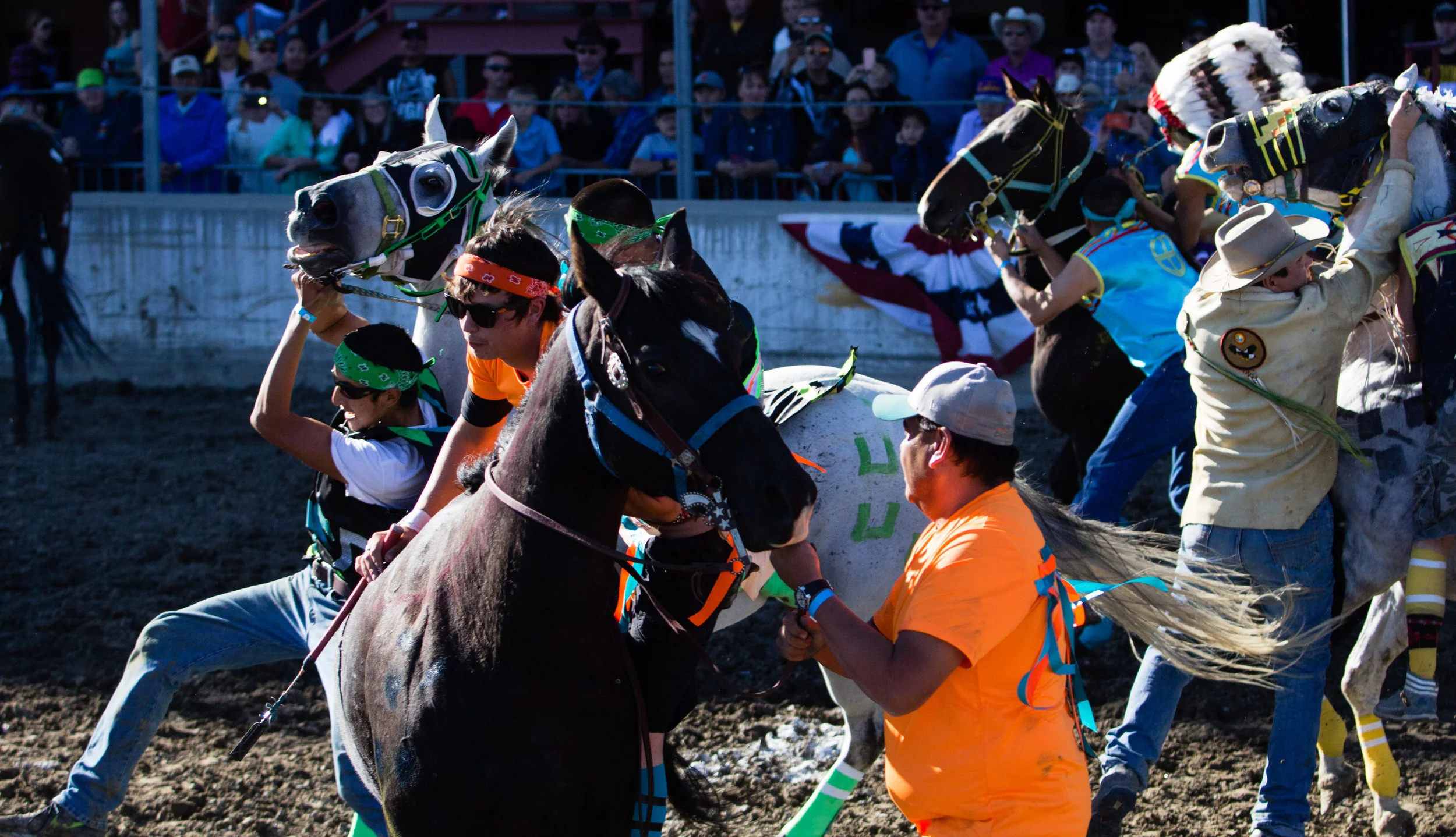 Riders struggle to mount their horses as the race begins during the All Nations Indian Relay Championships in Billings on September 25, 2016.