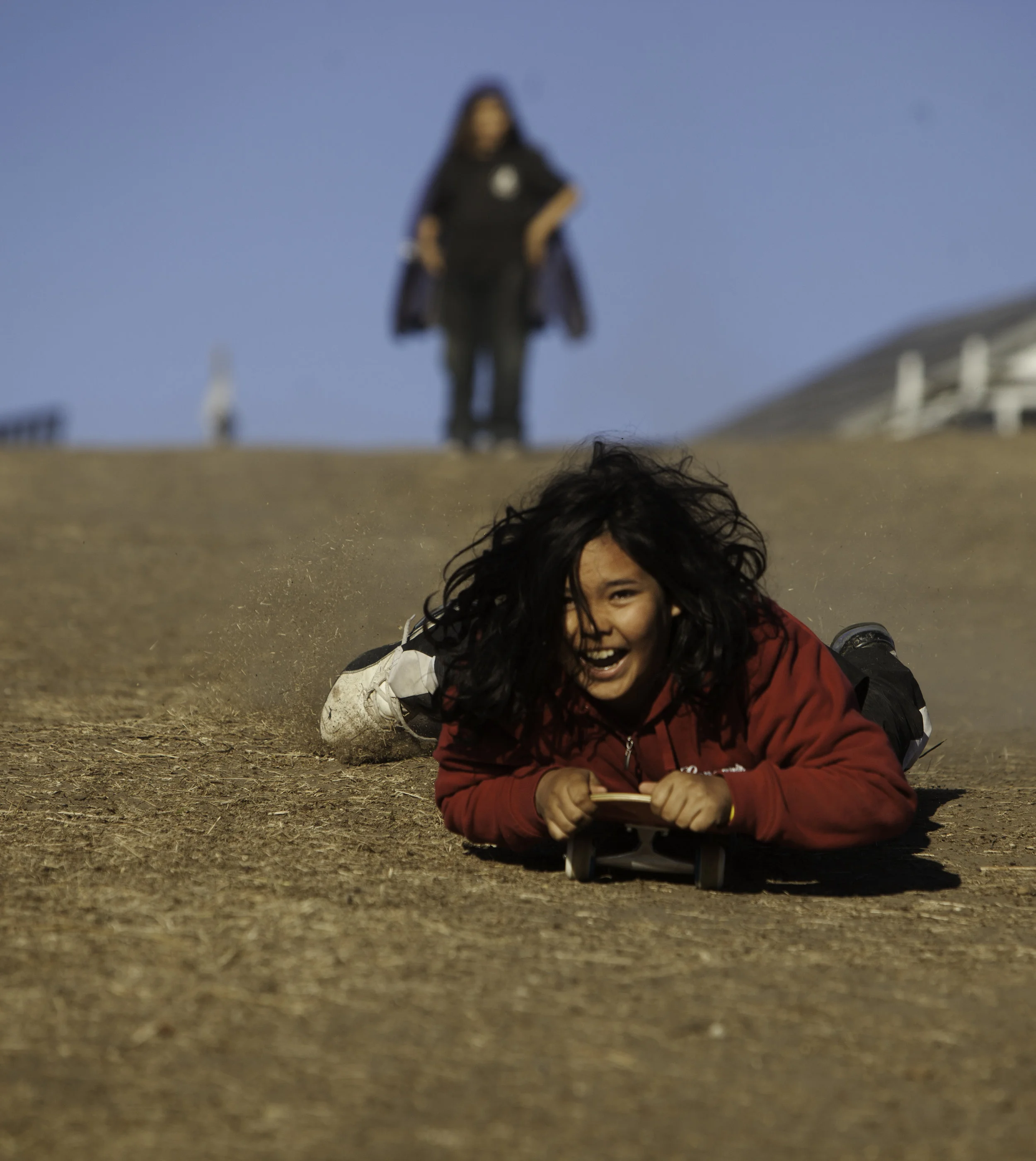 Kristen Wahquahbowhkuk, 11, flies down media hill on a skateboard donated to children at the Standing Rock protest camp. Wahquahbowhkuk and his family traveled from Kansas and have been at the camp for months.