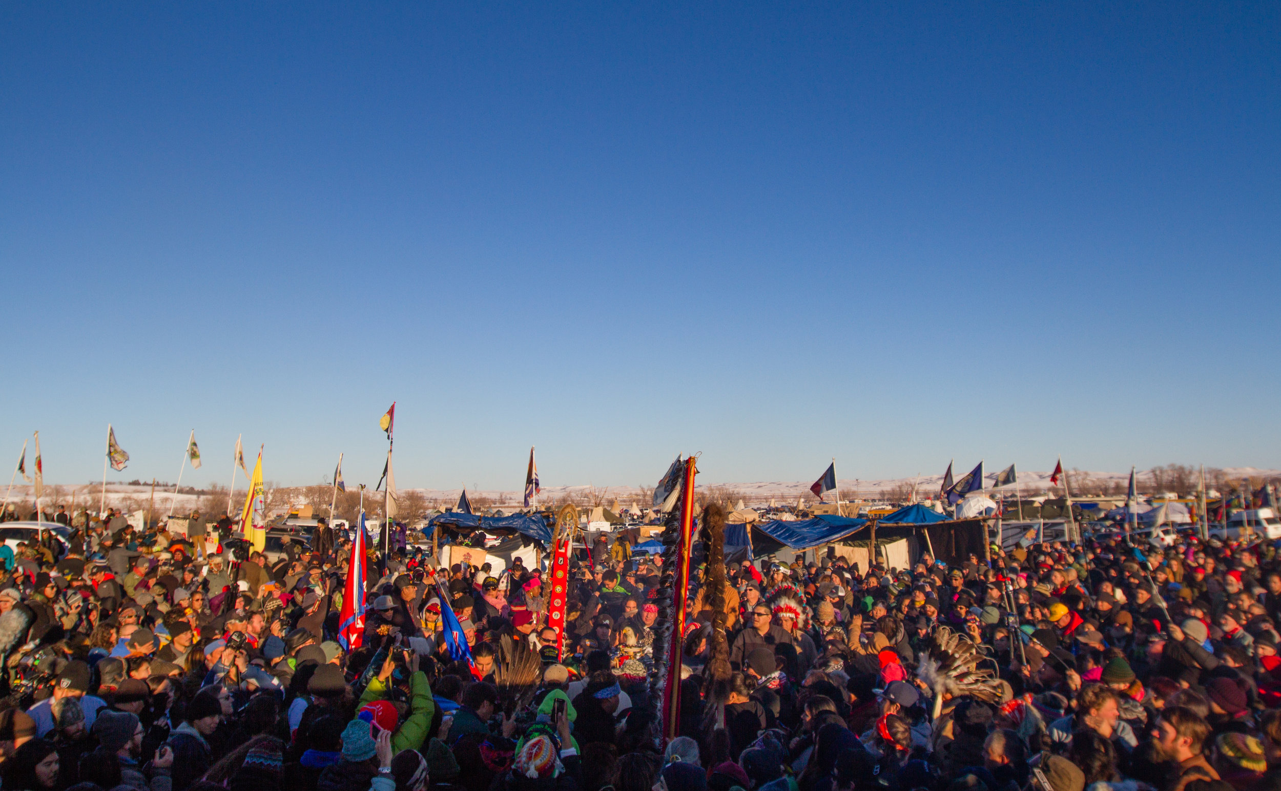 Dakota Access Pipeline protesters pour into the main area of the Oceti Sakowin camp at Standing Rock celebrating the Army Corps of Engineers decision to not grant permission for the Dakota Access Pipeline to cross under the Missouri river on December 4, 2016. 