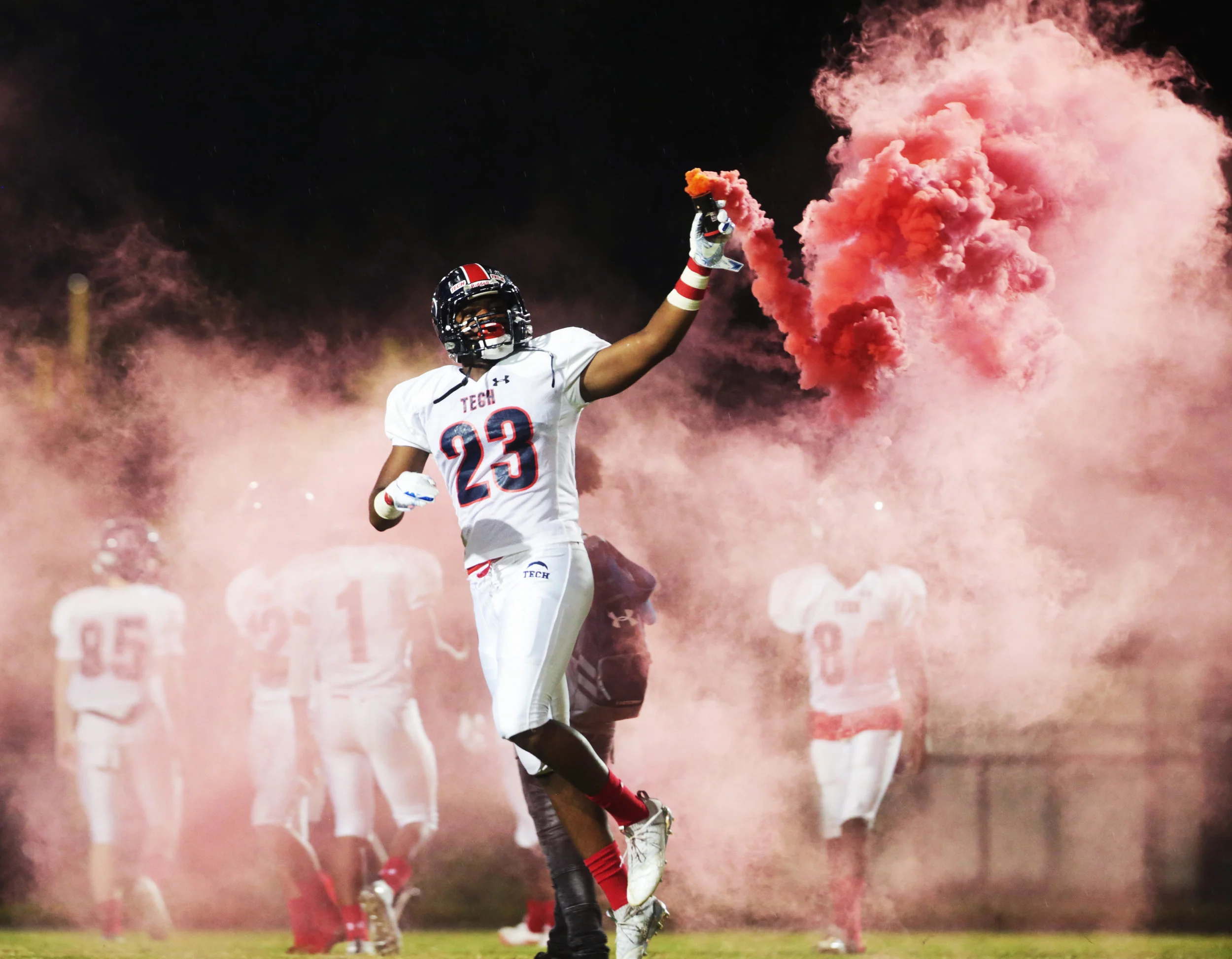  Tampa Bay Tech's Damion Bartley (23) carries a smoke bomb onto the field before the Armwood versus Tampa Bay Tech game at Armwood High School on August 24, 2018 in Seffner, Florida. 