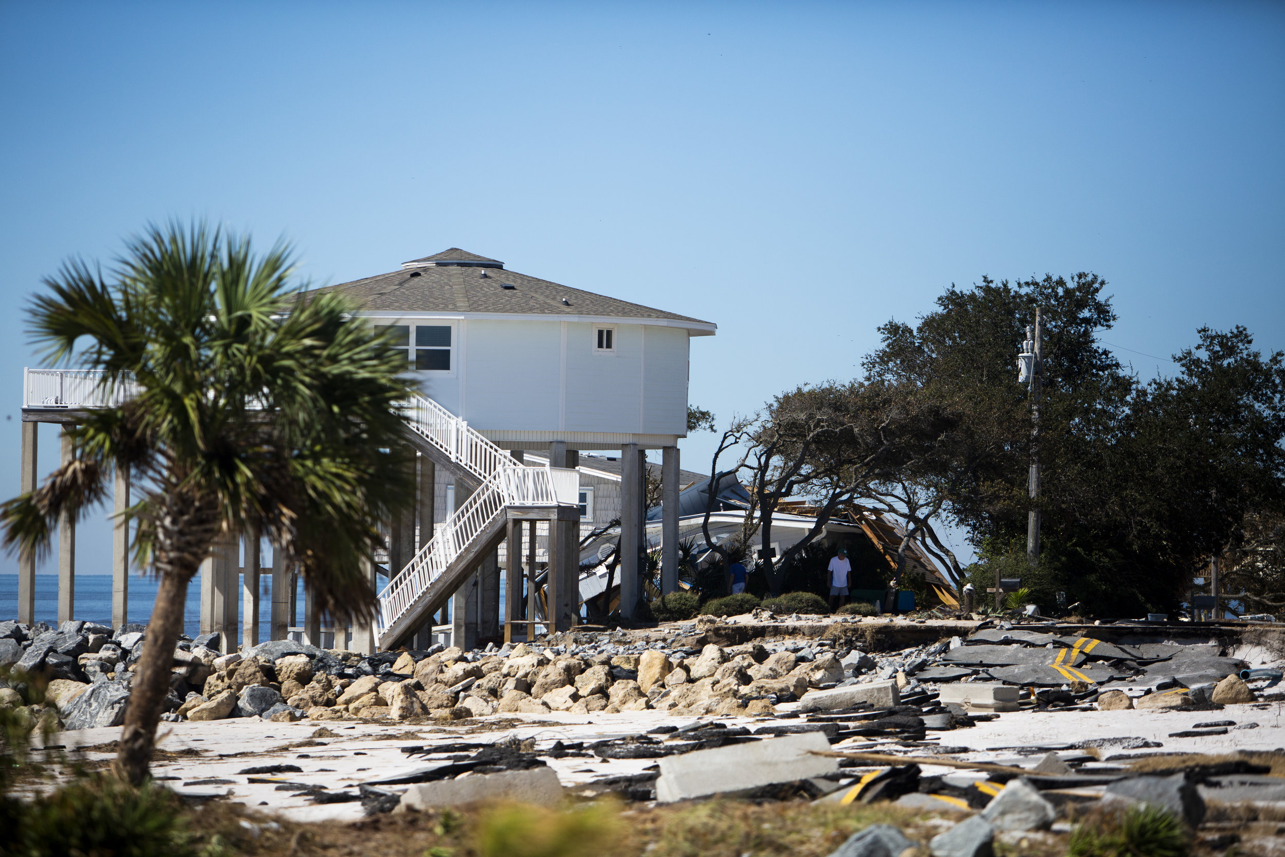 Residents assess the damage to their home after Hurricane Michael hit Alligator Drive in Alligator Point on October 12, 2018.