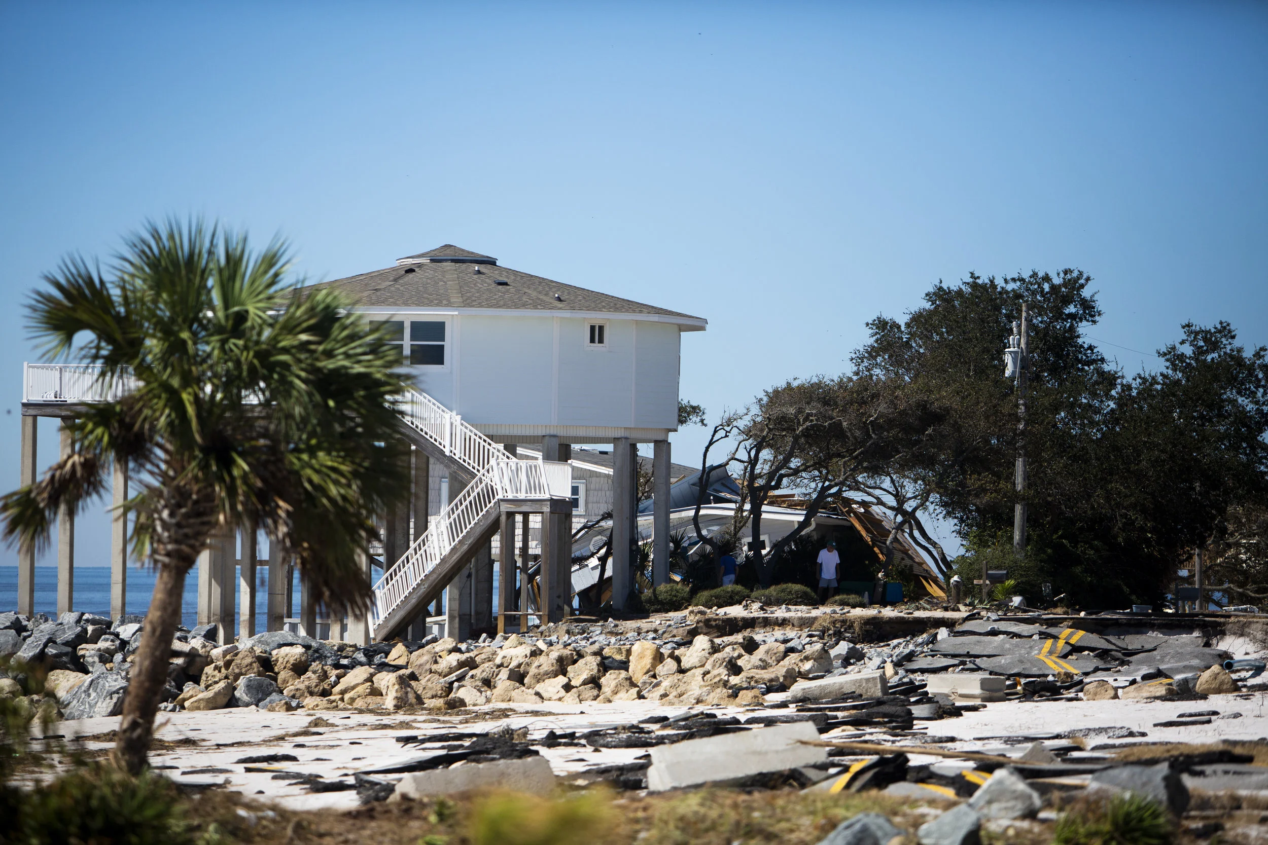 Residents assess the damage to their home after Hurricane Michael hit Alligator Drive in Alligator Point on October 12, 2018.
