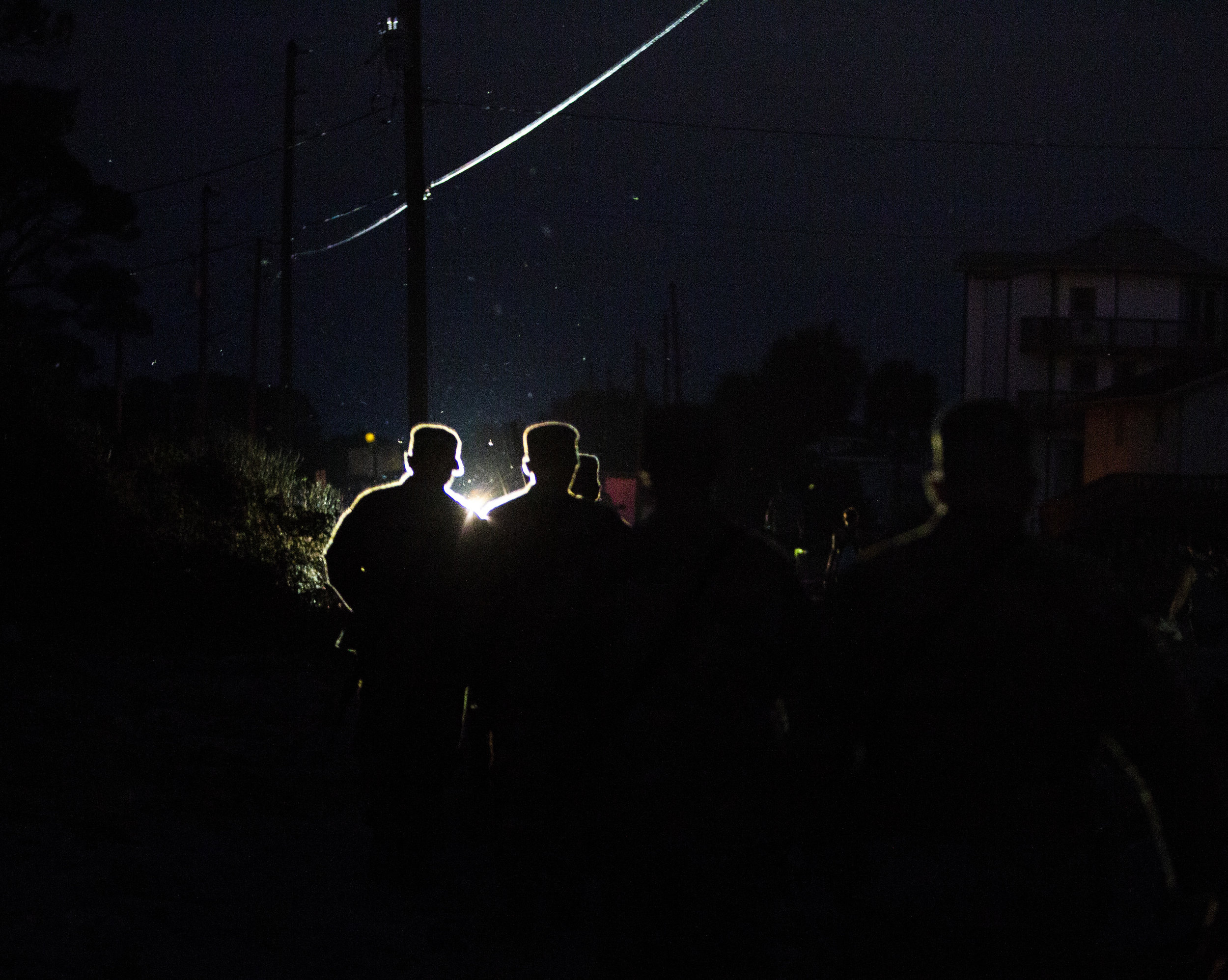  Members of Florida National Guard walk back to their trucks in the dark after patrolling Alligator Drive in Alligator Point on October 11, 2018, one day after Hurricane Michael hit the area. It may take weeks to restore power to parts of the Florida