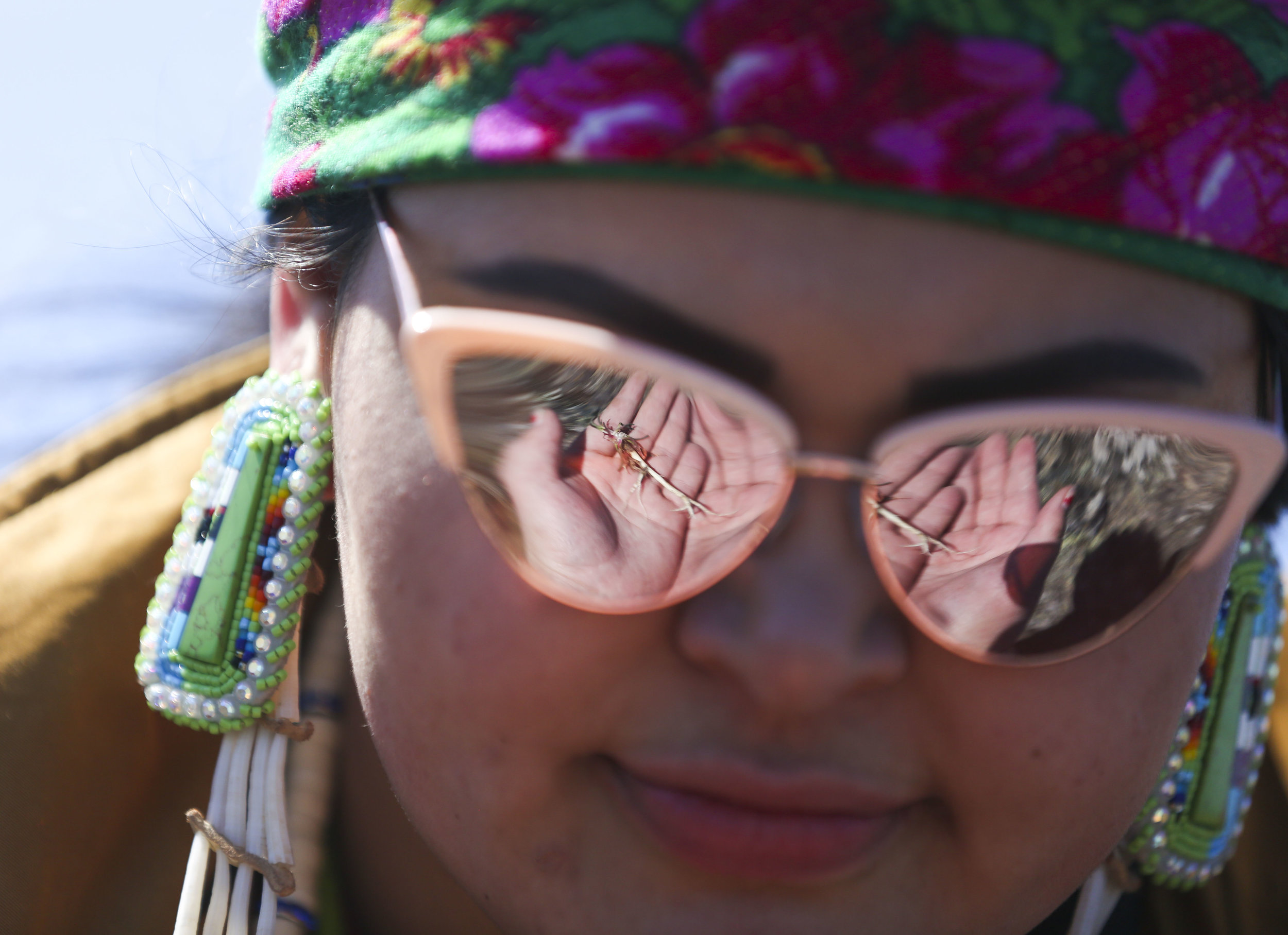  Iaitia Farrell, 19, picks sp̓eƛ̓m (bitterroot) with a class from the Salish School of Spokane on April 29, 2019. Sp̓eƛ̓m was a staple food for the Salish people. The Salish School of Spokane is a Salish language immersion school dedicated to teachin