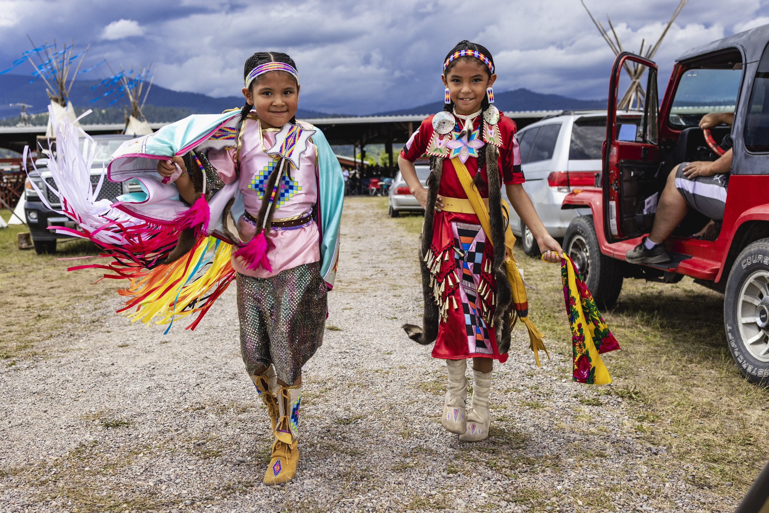   Harmony, 6, and Braylin Kickingwoman, 7, chose the colors for their outfits, which their parents designed. The girls compete in dance categories at the powwows.  