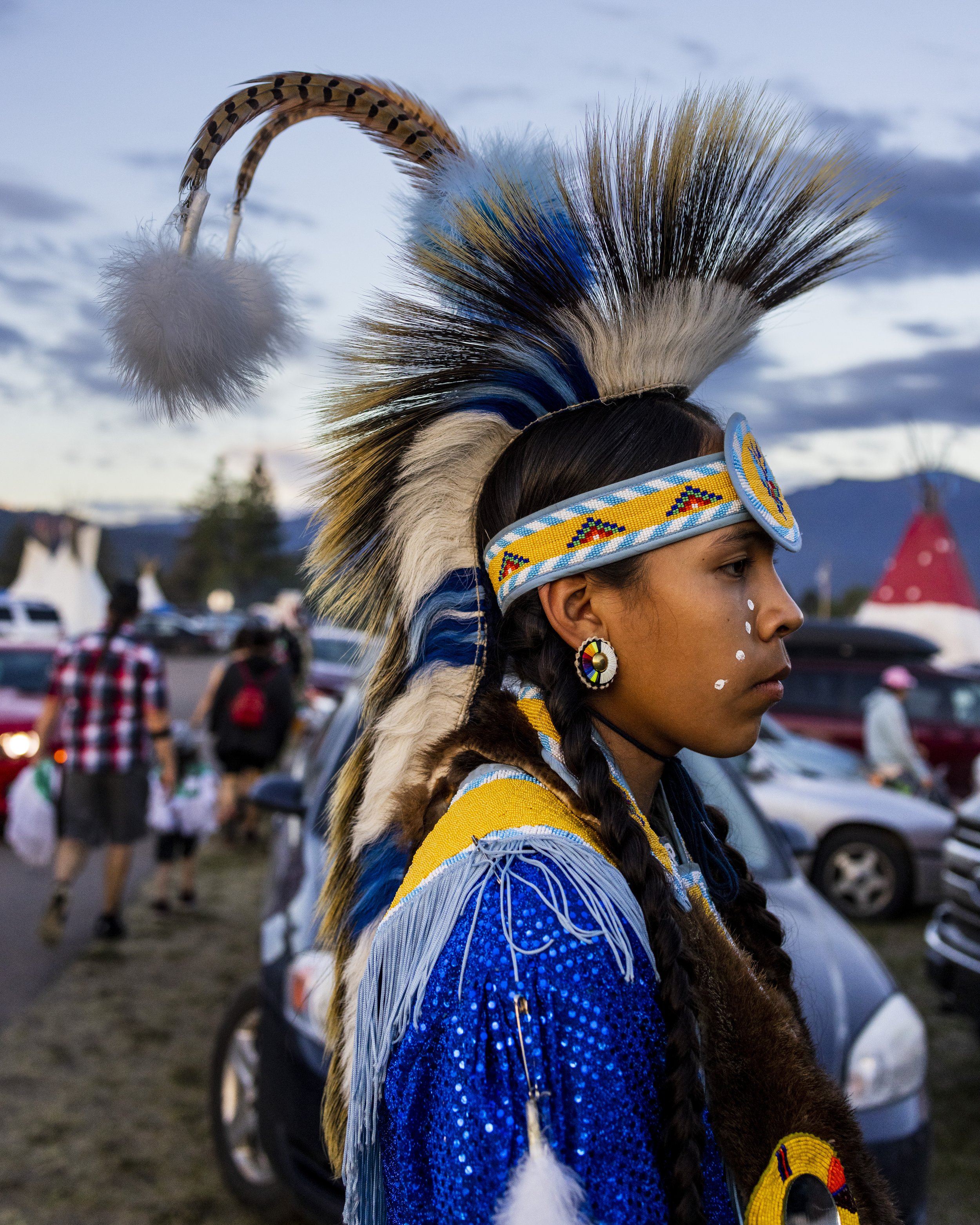   Ansen Eagletail, 14, prepared for the procession of dancers known as Grand Entry, which marks the beginning of the competition.  