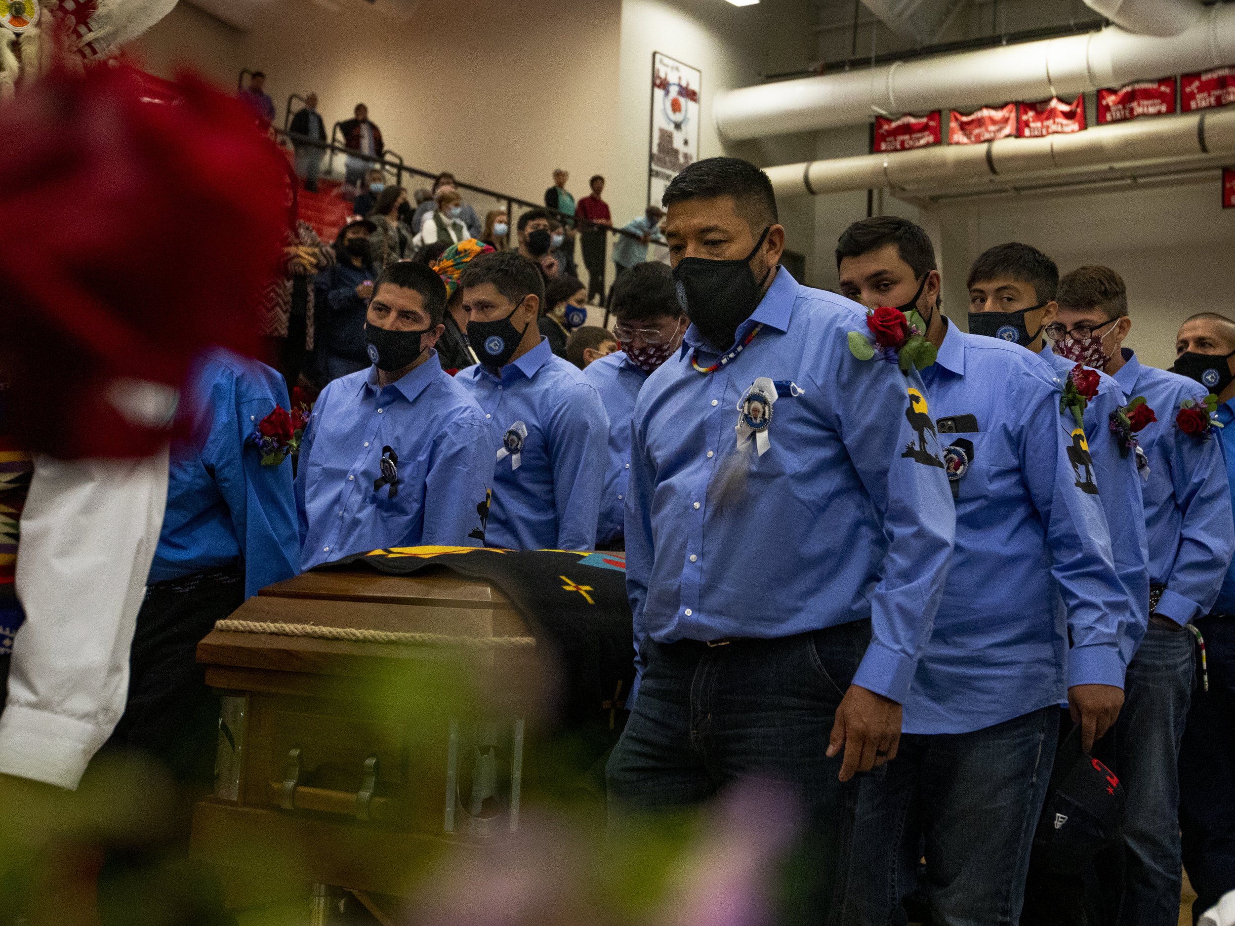  Pallbearers dressed in Chief Old Person’s signature shirt carried him out of the gym after Friday’s funeral. 