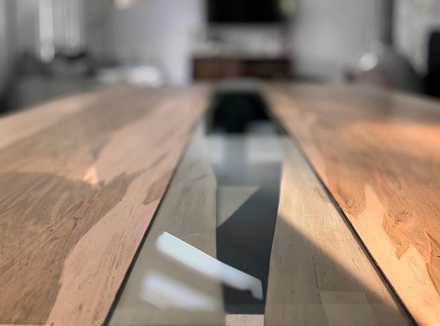 Close-up of our custom wormy maple double slab dining table with glass bridge center ➖➖