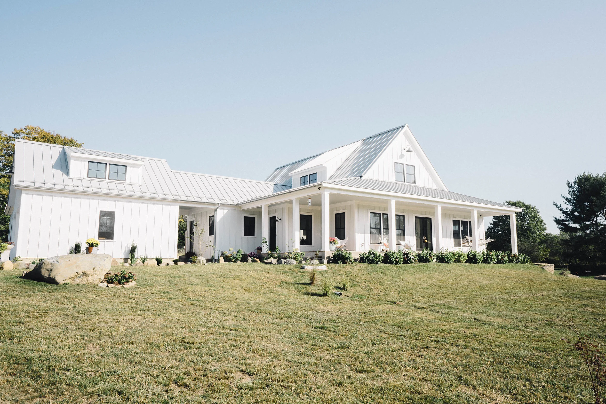 Built in 2016, this Modern Industrial Farmhouse fulfilled a personal dream. Loosely based on a house plan found online, Alexander modified the floor plan to include a foyer, walk-in pantry, mudroom and guest suite on the second floor. "Our top priority was building a beautiful home that performed at a very high level of sustainability. We selected a site with a perfect south-facing orientation to take advantage of passive solar heat gains. The home is extremely well insulated — built with 12" double stud walls filled with dense pack cellulose. It utilizes a geothermal system for heating and cooling and solar panels which bring the home to net-zero." Photos by Kelly M. Shea