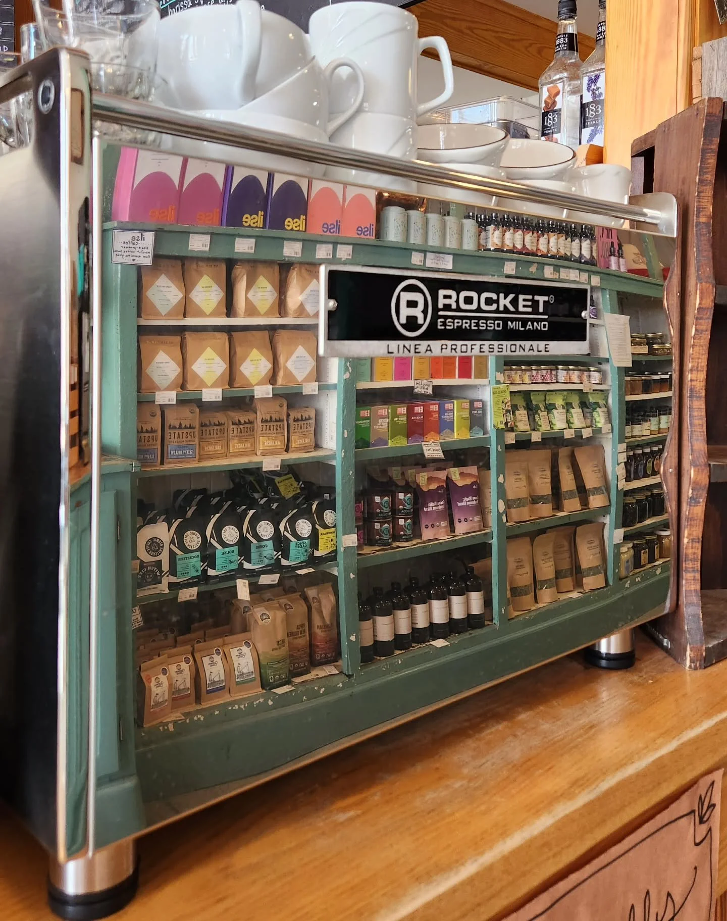 Reflection of our coffee + tea shelves in the Rocket! She's puuuurdy. 
.
.
.
#randomharvestmarketandcafe #upstatenycoffee #hudsonvalleycoffee #espressomachine #rocketespresso