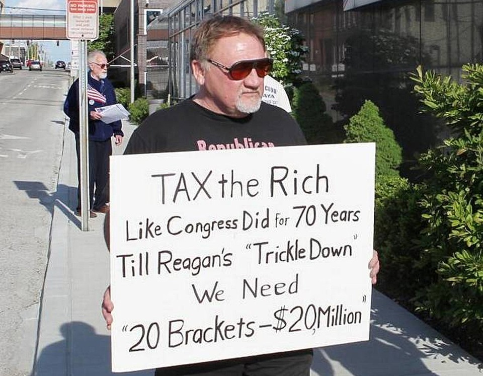 In this undated file photo, James Hodgkinson holds a sign during a protest outside of a U.S. Post Office in Belleville, Illinois. 