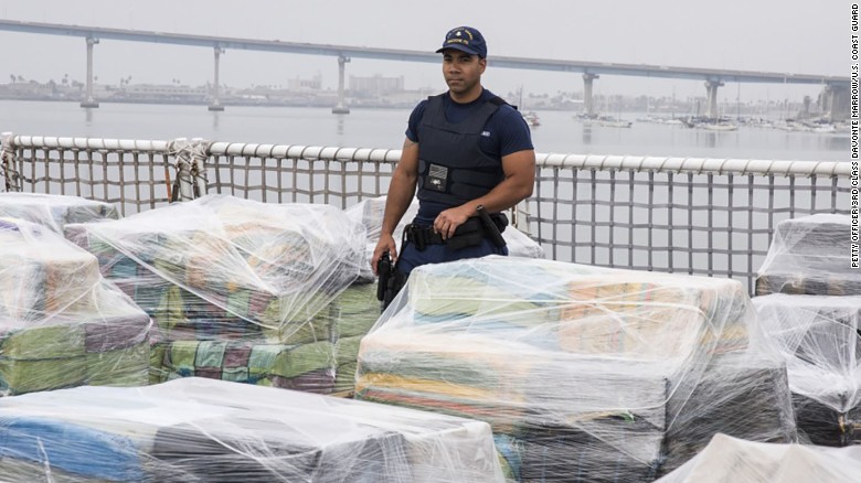 A US Coast Guard team member guards an 18-ton cocaine haul.
