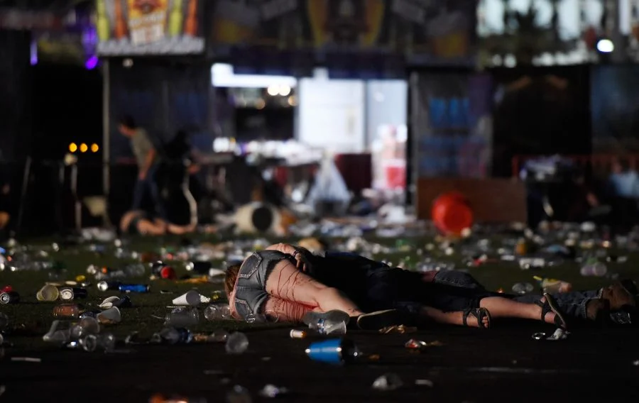 A person lies on the ground covered with blood at the Route 91 Harvest country music festival after apparent gun fire was heard on October 1, 2017 in Las Vegas, Nevada. There are reports of an active shooter around the Mandalay Bay Resort and Casino. (Photo by David Becker/Getty Images) 