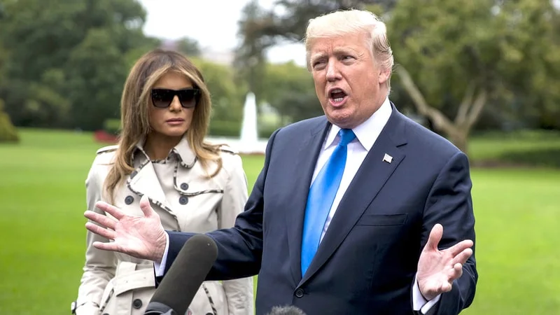 U.S. President Donald Trump, right, speaks to members of the media as First Lady Melania Trump stands before boarding Marine One on the South Lawn of the White House in Washington, D.C., U.S., on Friday, Oct. 13, 2017. Trump plans to visit the U.S. Secret Service training facility in Beltsville, Maryland.Al Drago/Bloomberg via Getty Images