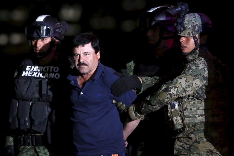 Joaquín "El Chapo" Guzmán is escorted by soldiers during a presentation at a hangar in Mexico City on January 8, 2016. REUTERS/Edgard Garrido