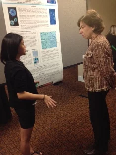 Dr. Birnbaum taking a moment to hear about Greta’s study at Brookhaven National Laboratory.