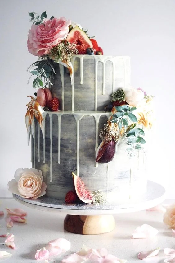 You don't even have to go crazy with the color. Whether you're having a vintage wedding, winter wedding, or a subtle beach wedding, color drip wedding cakes are perfect for any occasion.