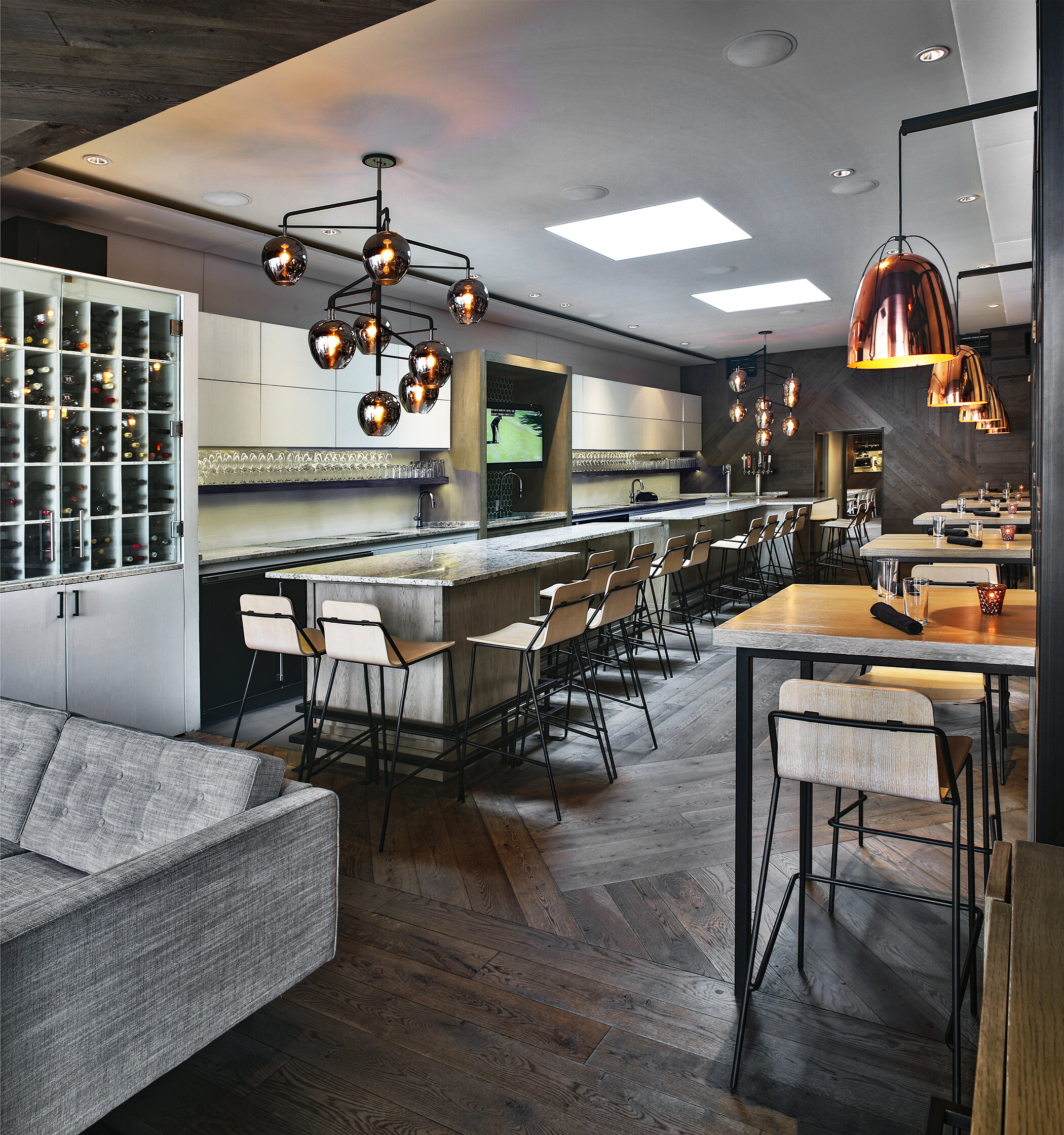 Front bar and hightop tables with decorative light fixtures at Town Hall restaurant in Jacksonville, FL