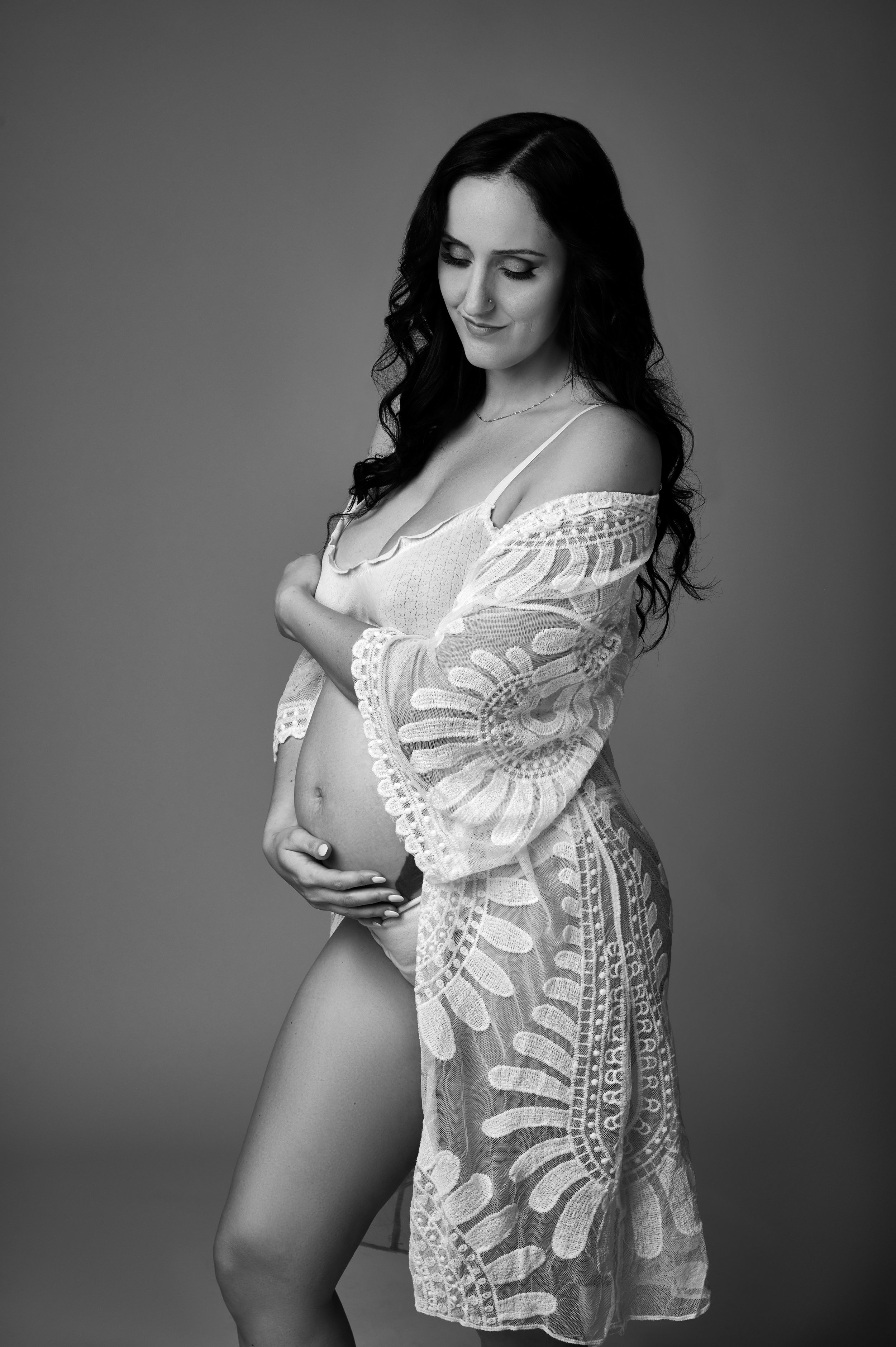 pregnant woman in floral robe studio photoshoot.jpg