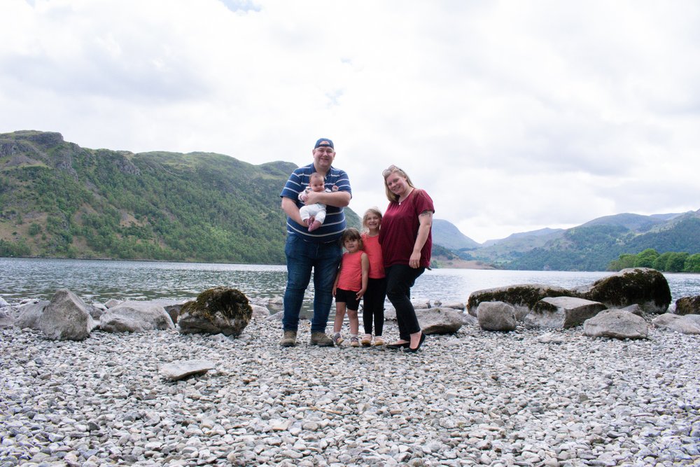 The Hassan family are stood on the lakeshore of Ullswater in 2020.