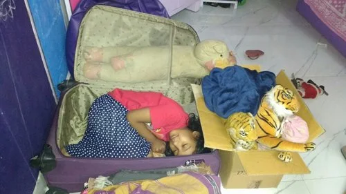 Niece Hiya, the inspiration behind Kangaroo Kisses , hides in Nandana's suitcase at bedtime, surrounded by her animal toys