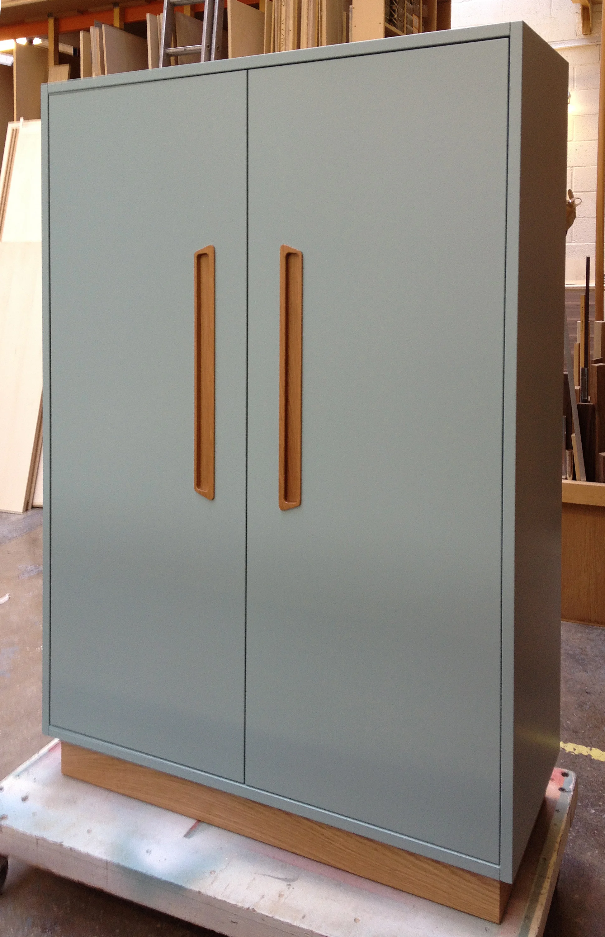 Freestanding cabinet with inlaid teak handles and lacquer finish