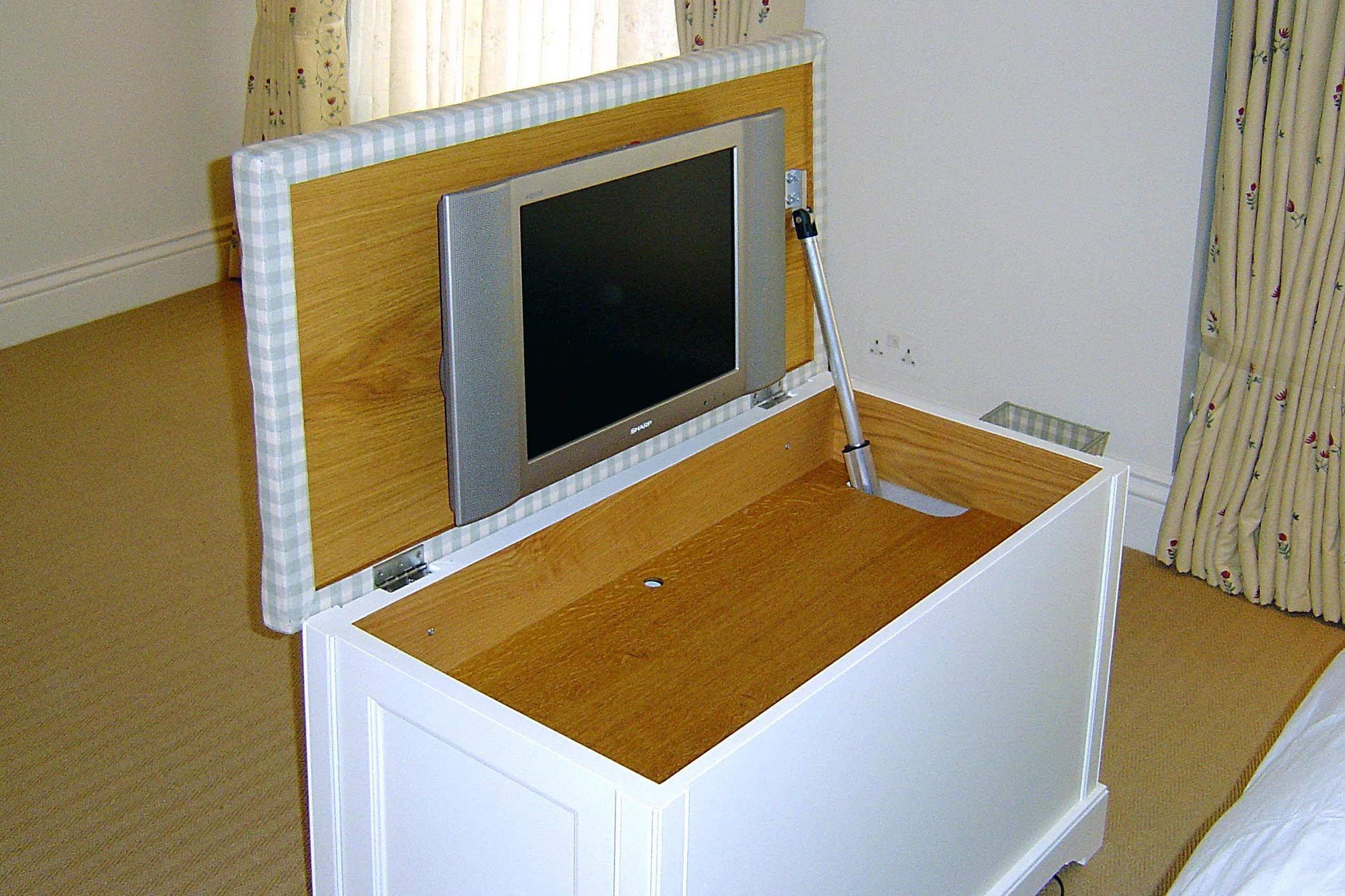 Natural wood interior with concealed mechanism compartment